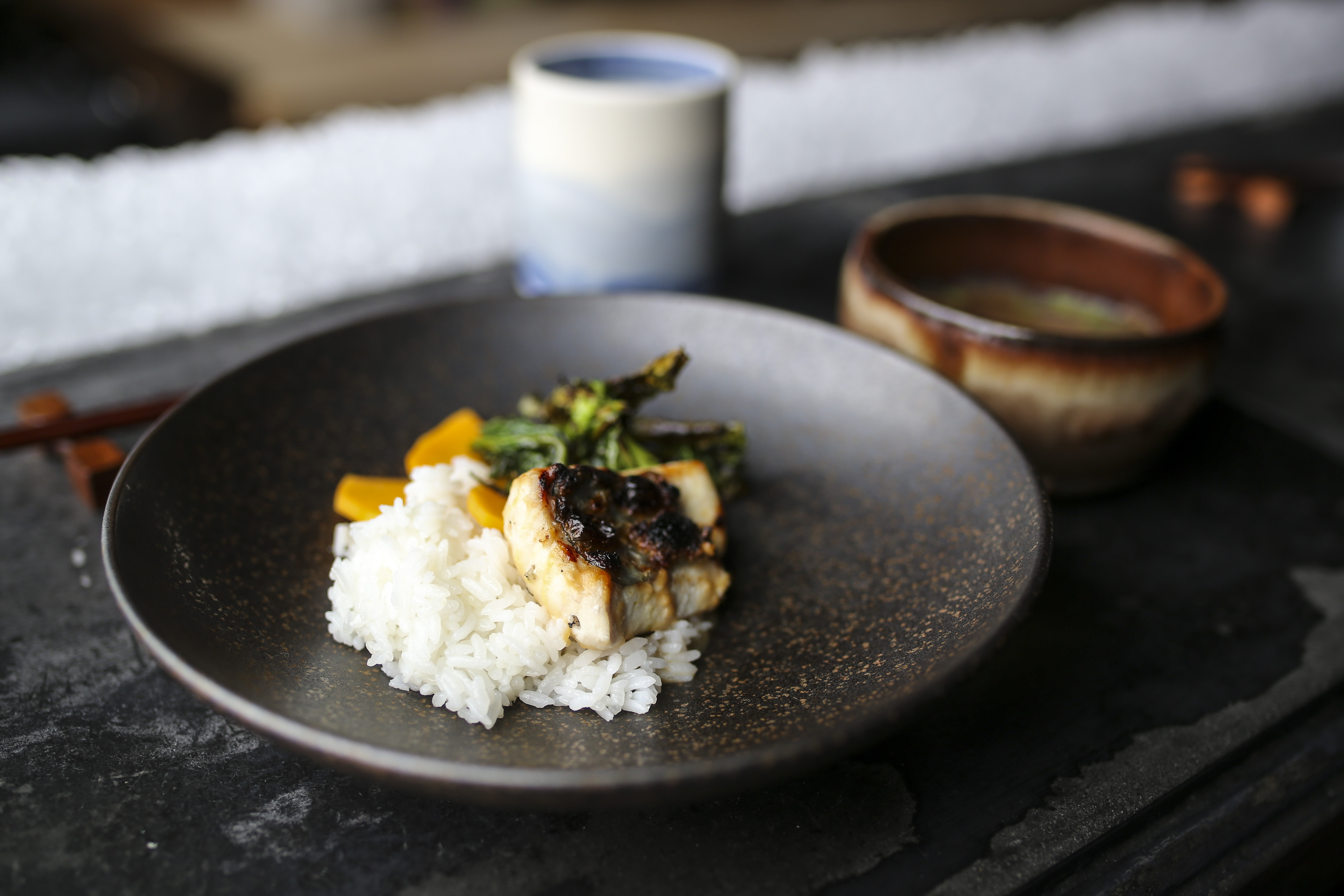 Grilled John Dory served with rice, Chinese broccoli, and pickled butternut squash with a side of squash broth at Big King in Providence.
