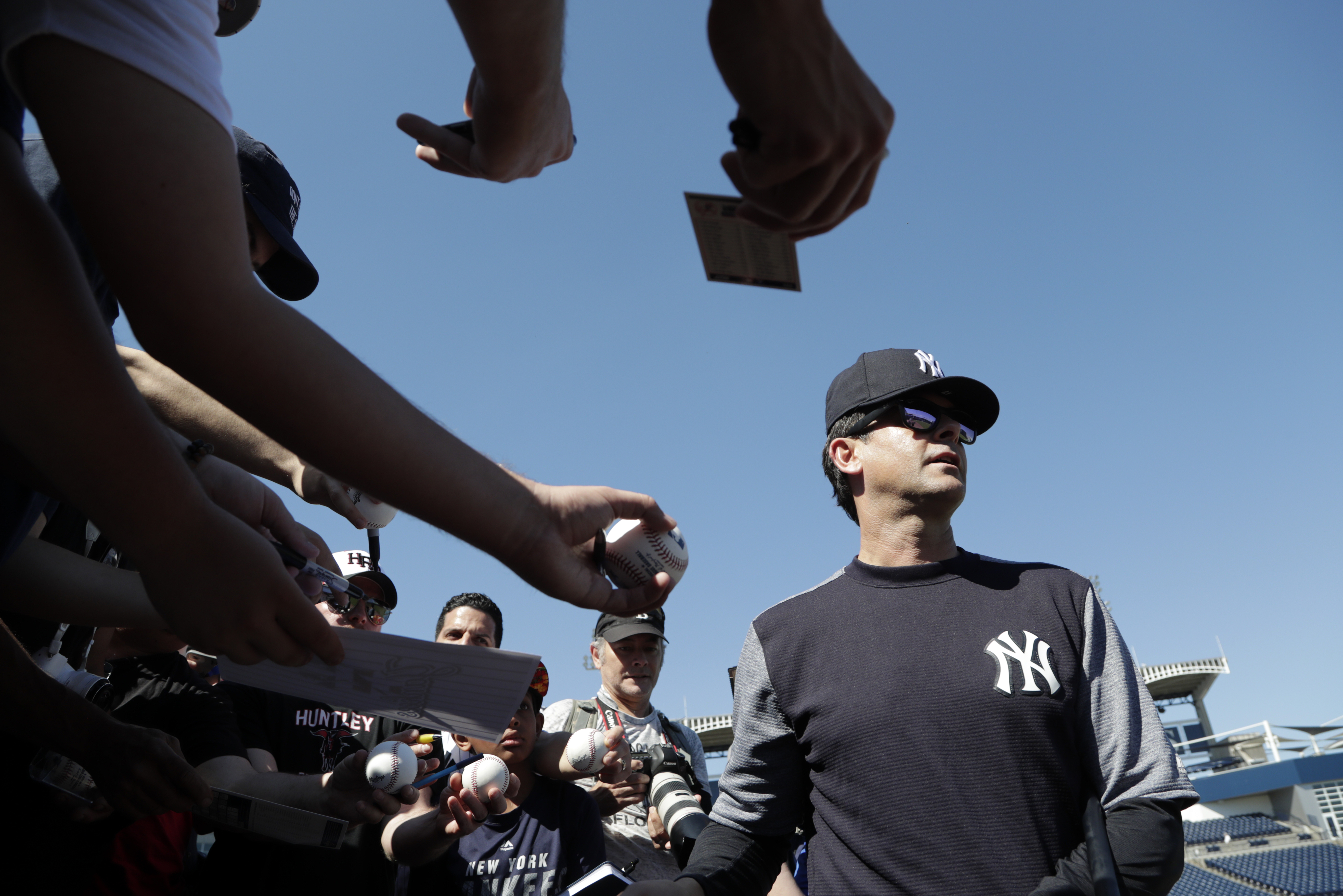Aaron Boone walks away after signing autographs at spring training last month.