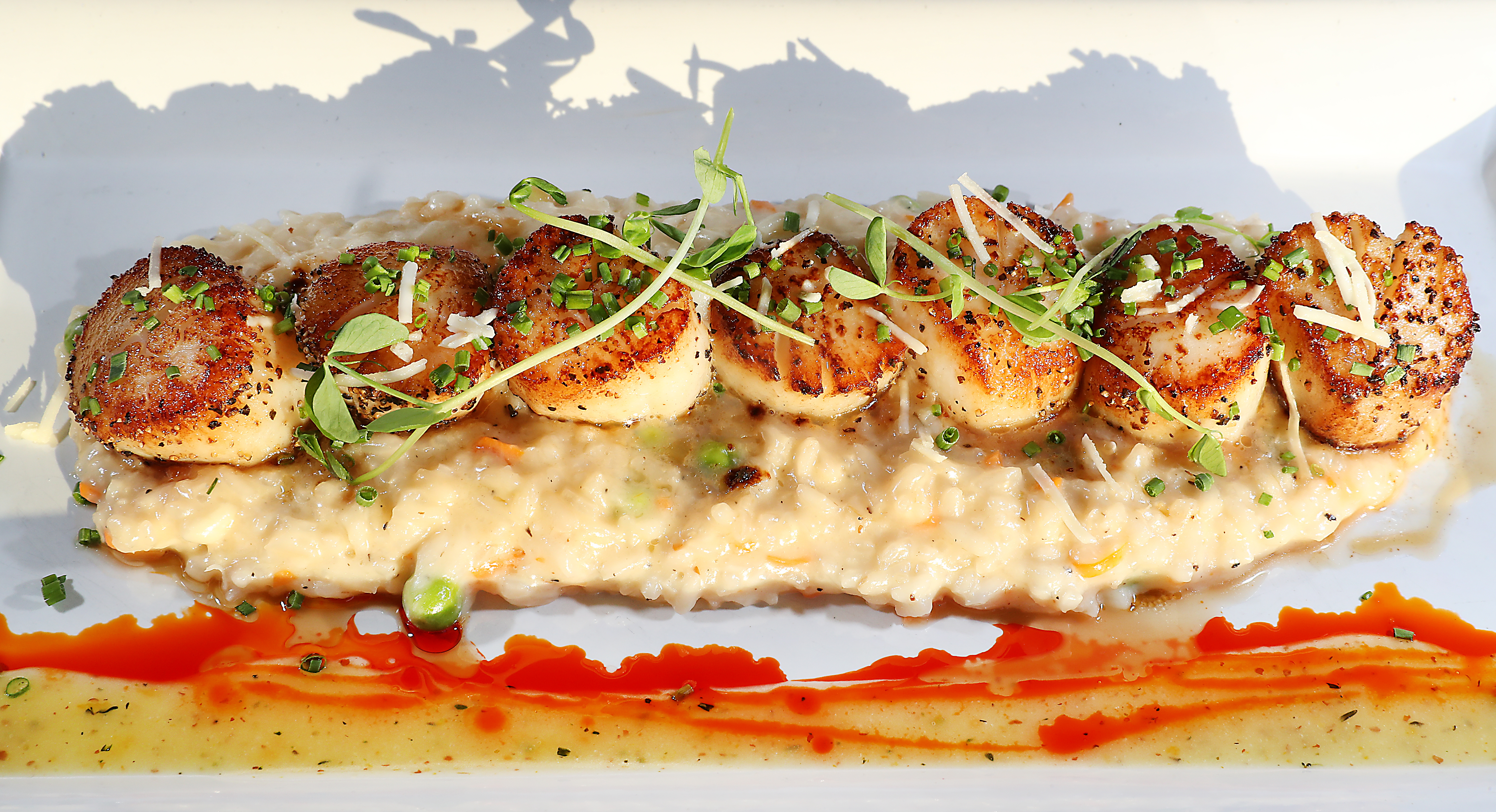 The scallops, served with a cheesy risotto and peas.