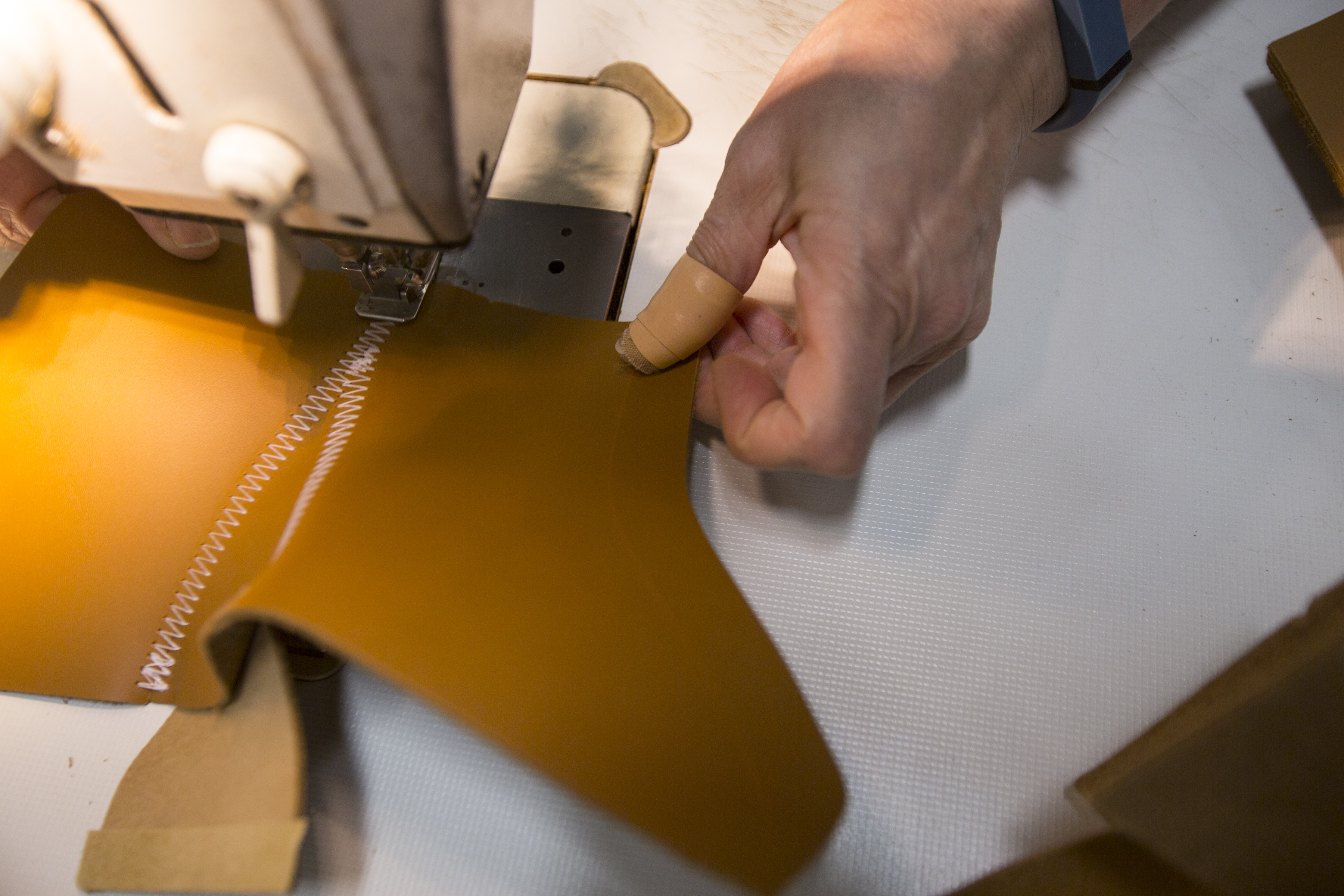 A bootmaker sewed pieces together to make the top of the Bean Boot.