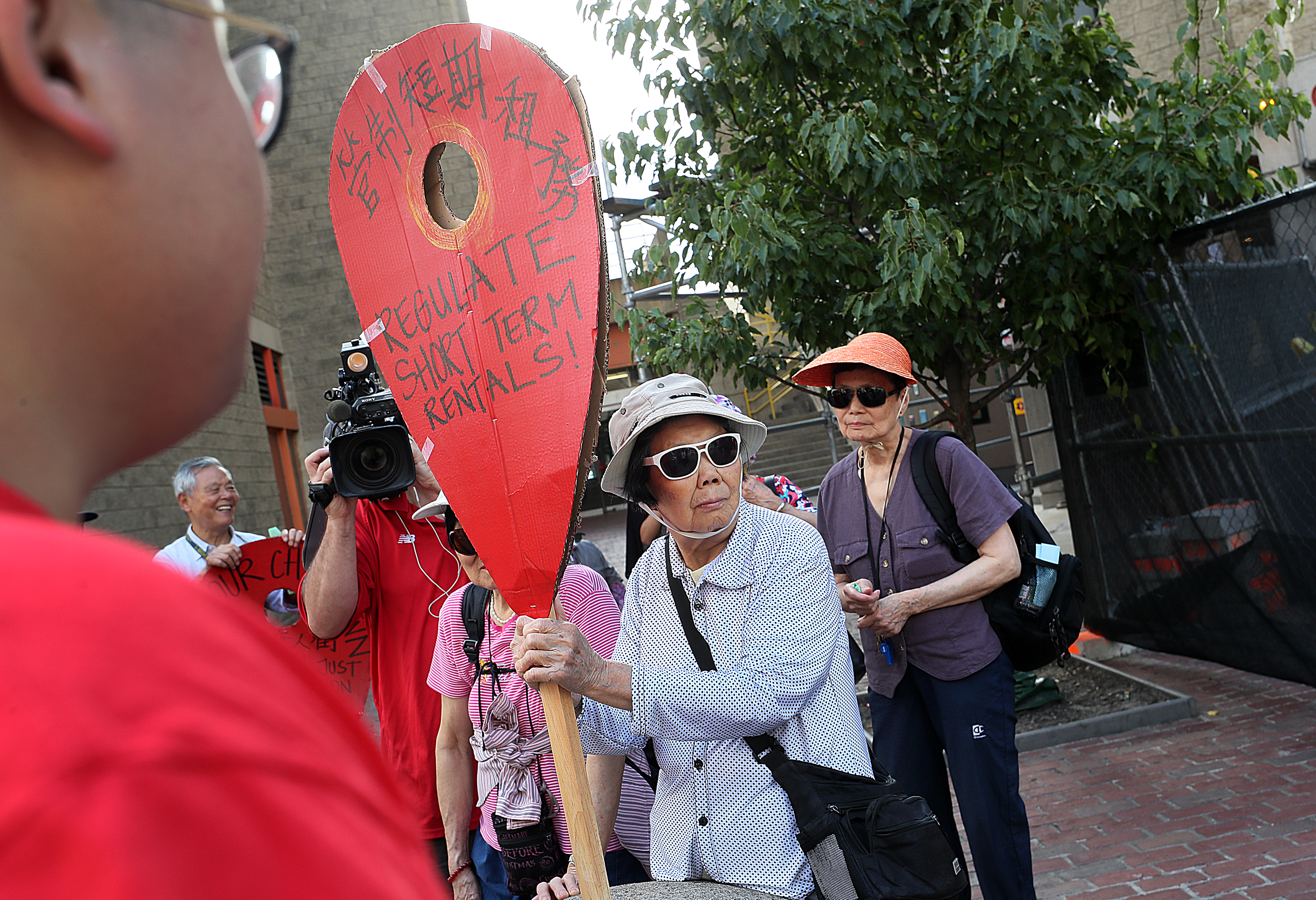 Dierong Lin held a protest sign in Chinatown on Thursday.