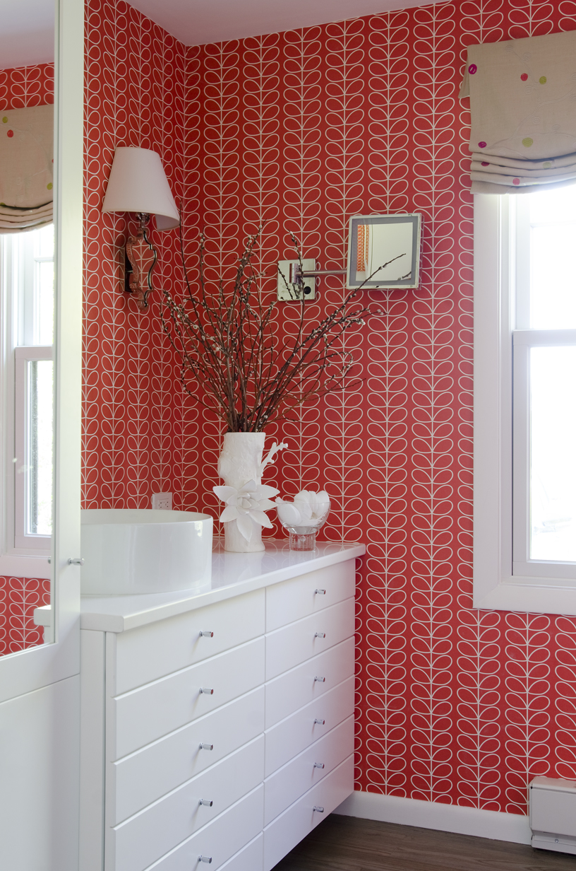 Orla Kiely wallpaper brightens the first floor bathroom. Located off the kitchen, it serves as both master bath and powder room.