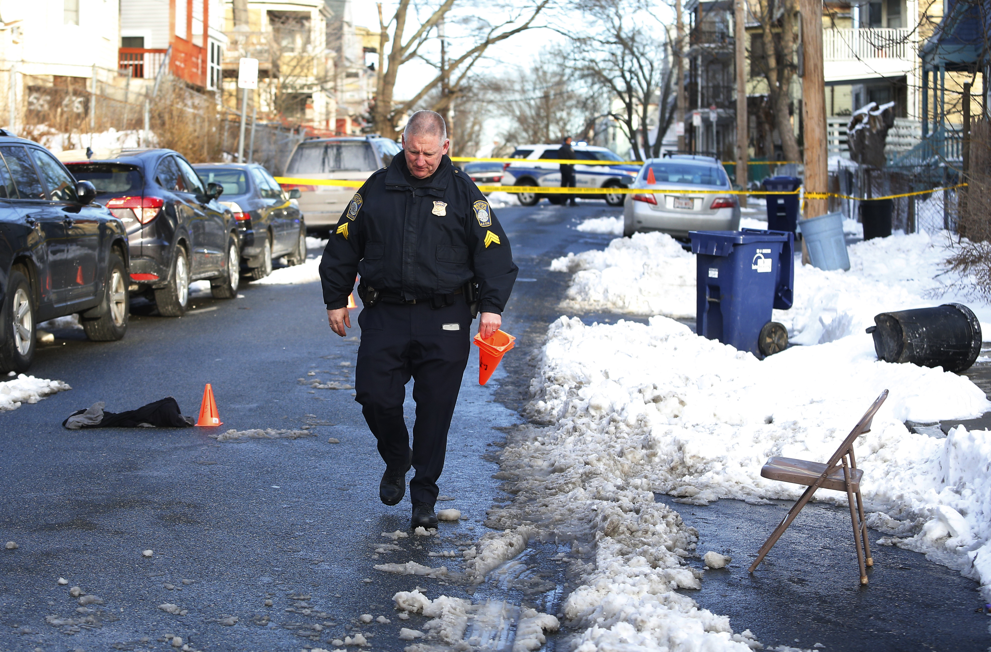 A police officer walked down Nightingale Street in Dorchester, where a man was shot.