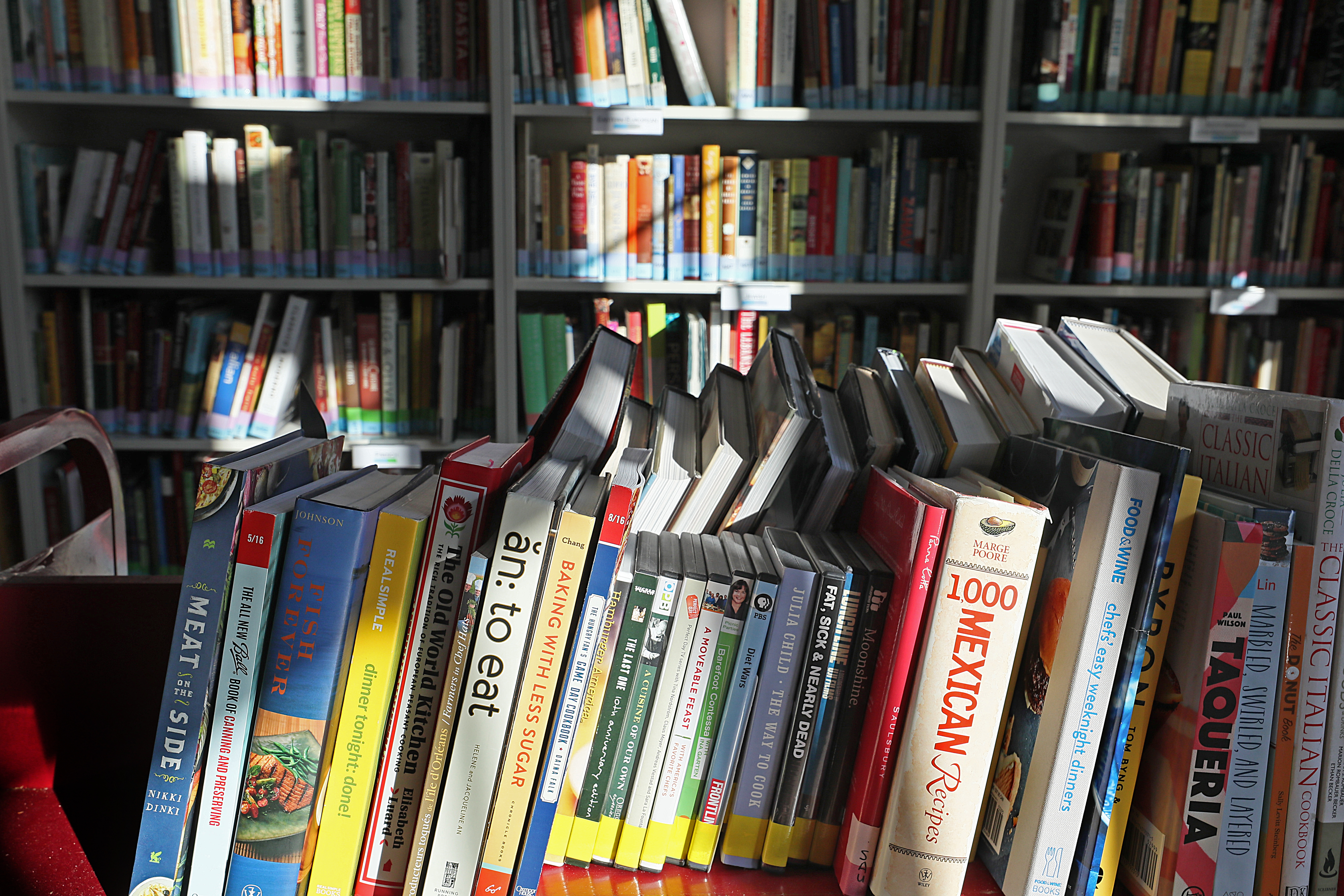 A portion of America’s Test Kitchen’s 4,000-plus-volume cookbook library.