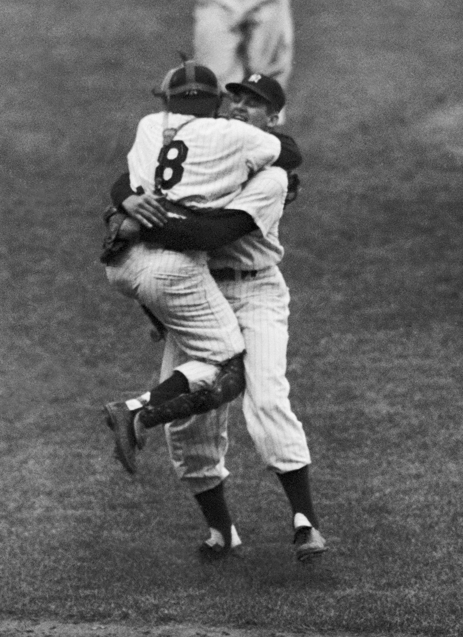 Yankees catcher Yogi Berra leaps into the arms of Don Larsen after Larsen completed his perfect game.