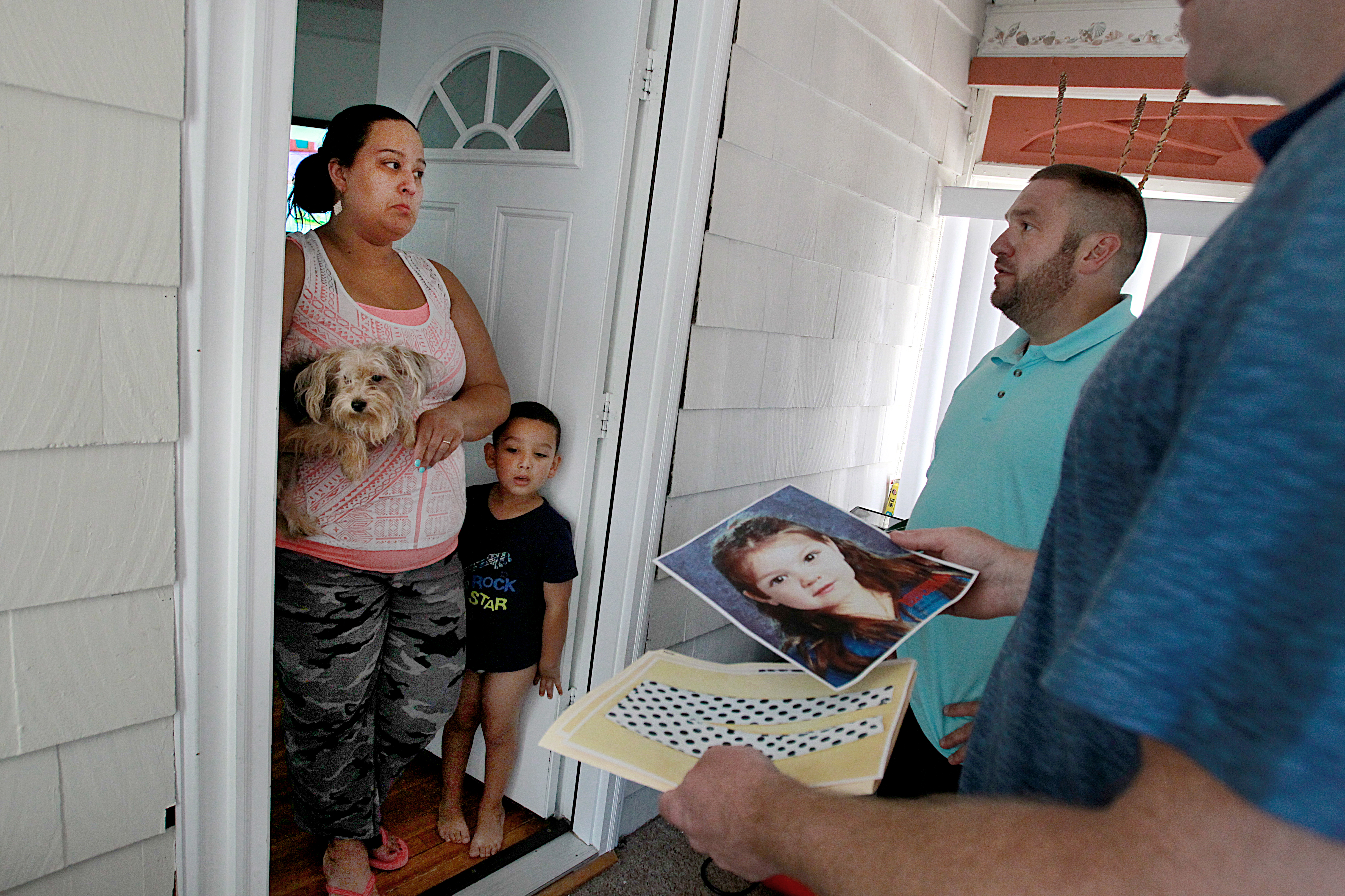 Winthrop Detectives Timothy Callinan (far right) and Wayne Carter followed up on a Baby Doe tip with Andrea Mesa and her son Anthony.