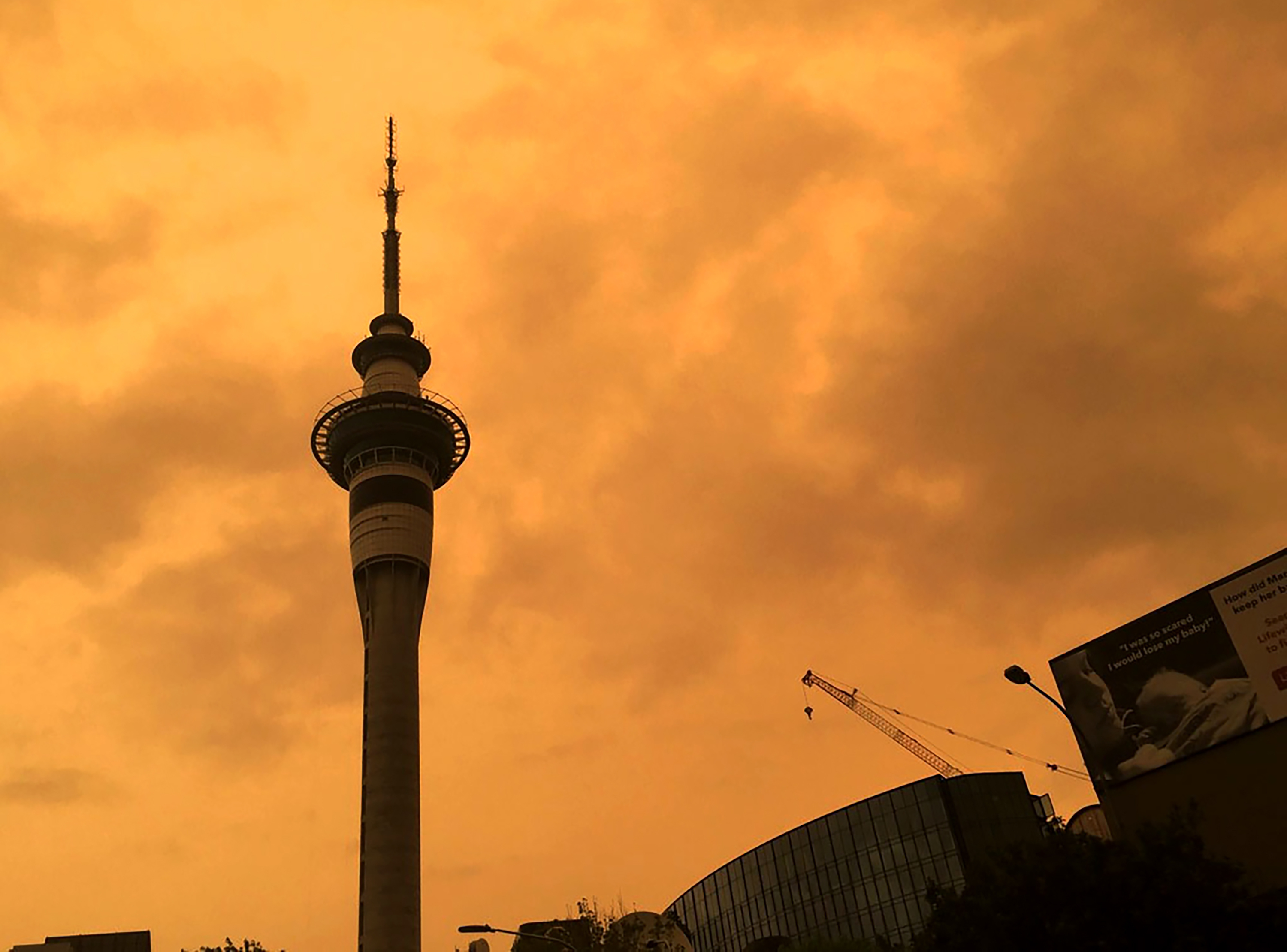 The sky above Auckland's Sky Tower turned orange as smoke from the Australia wildfires arrived in New Zealand, Sunday.