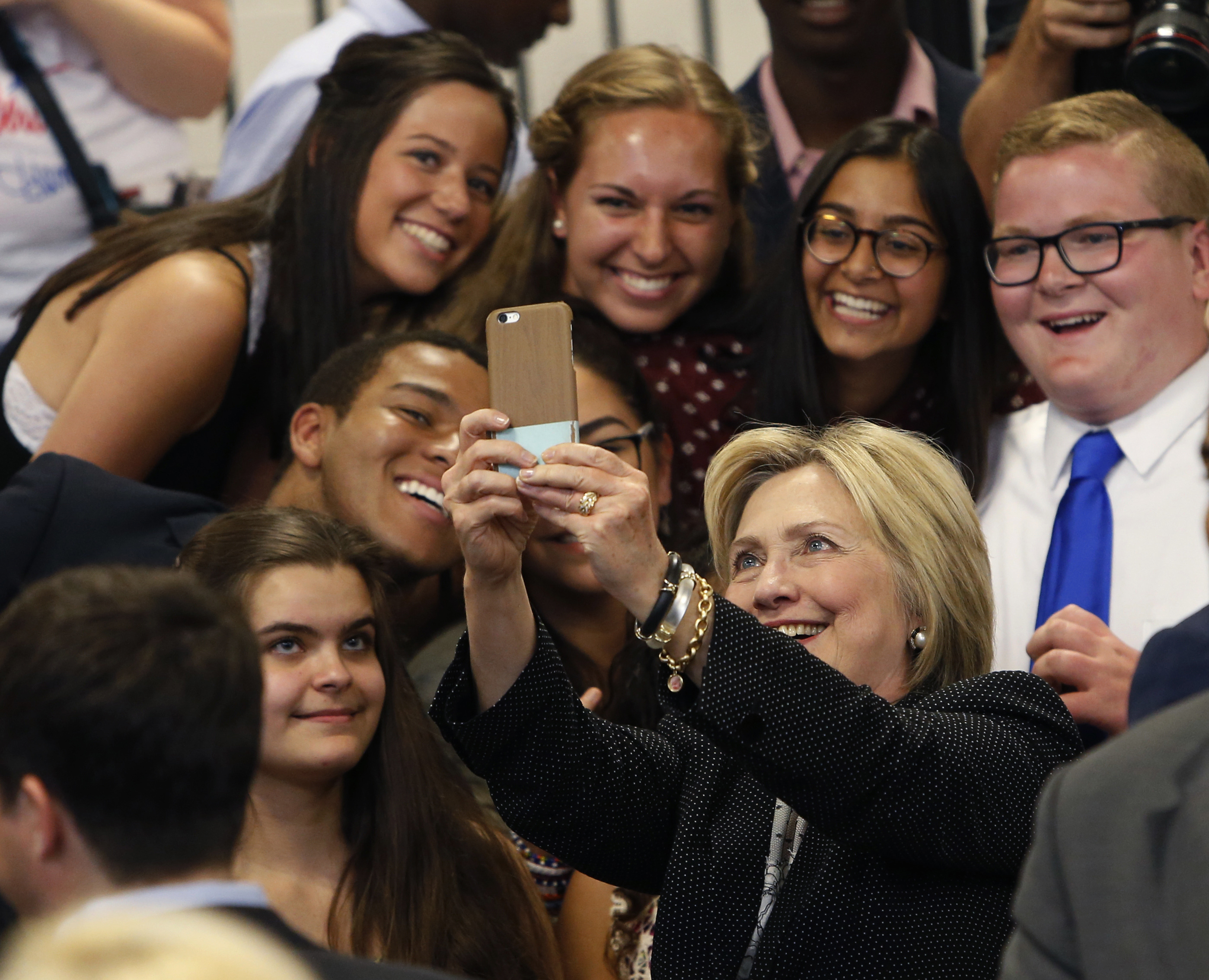 In this June 21, 2016, file photo, Hillary Clinton takes a photo with supporters after speaking at Fort Hayes Vocational School in Columbus, Ohio.