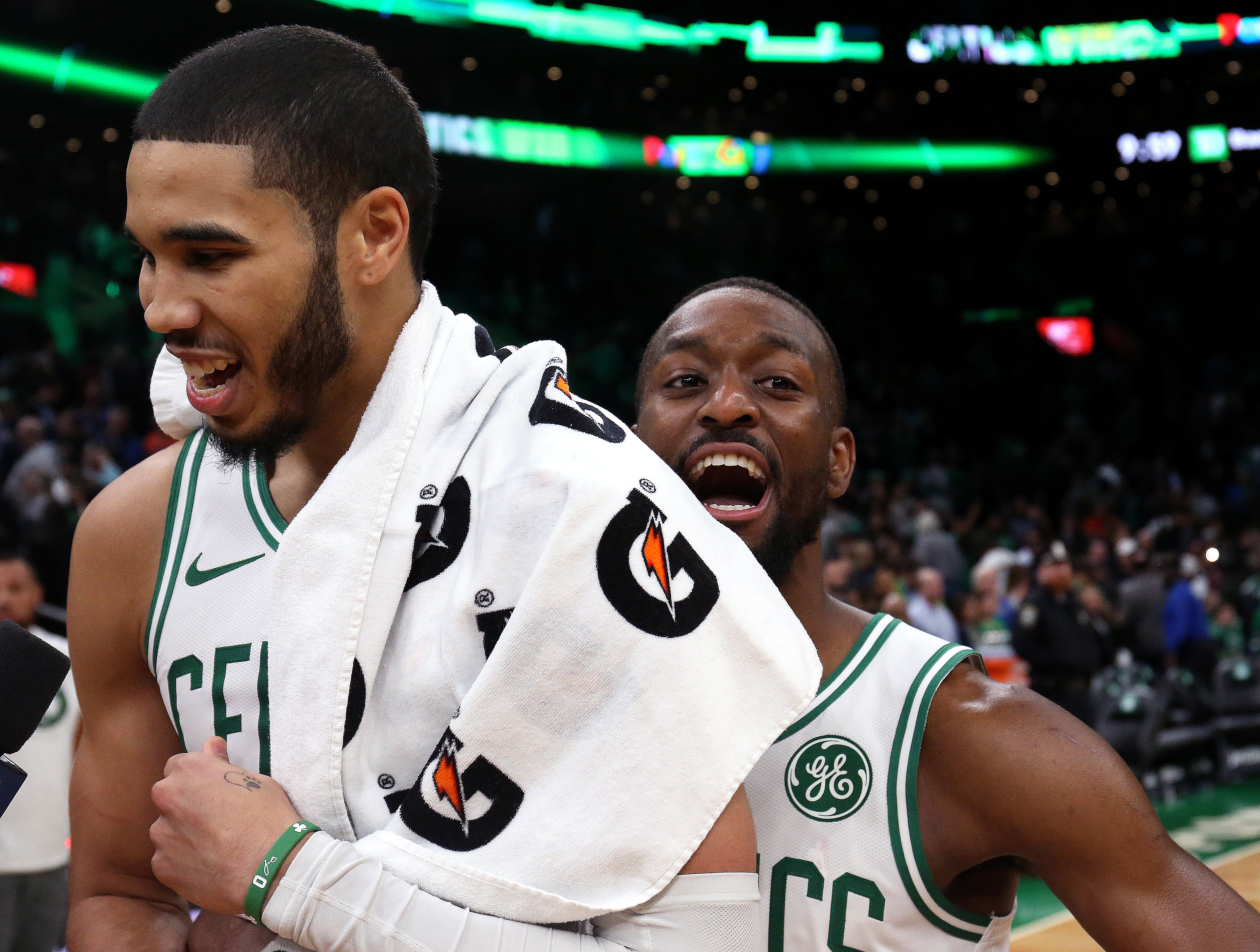 A jubilant Jayson Tatum (left) celebrates with Kemba Walker after hitting the winning shot in Friday night’s game.