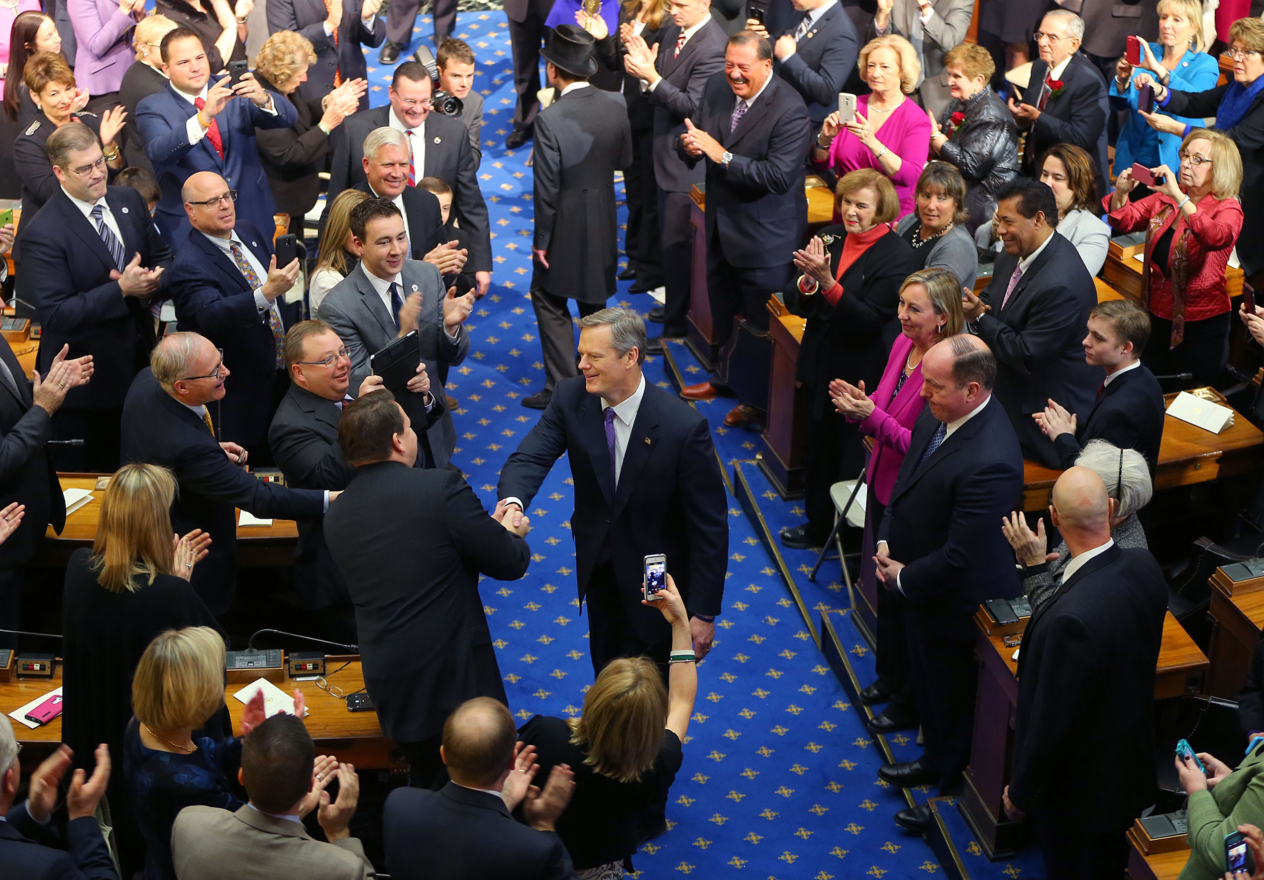 Charlie Baker was greeted by members of the Masschusetts Legislature on Thursday, the day he was sworn in as governor.