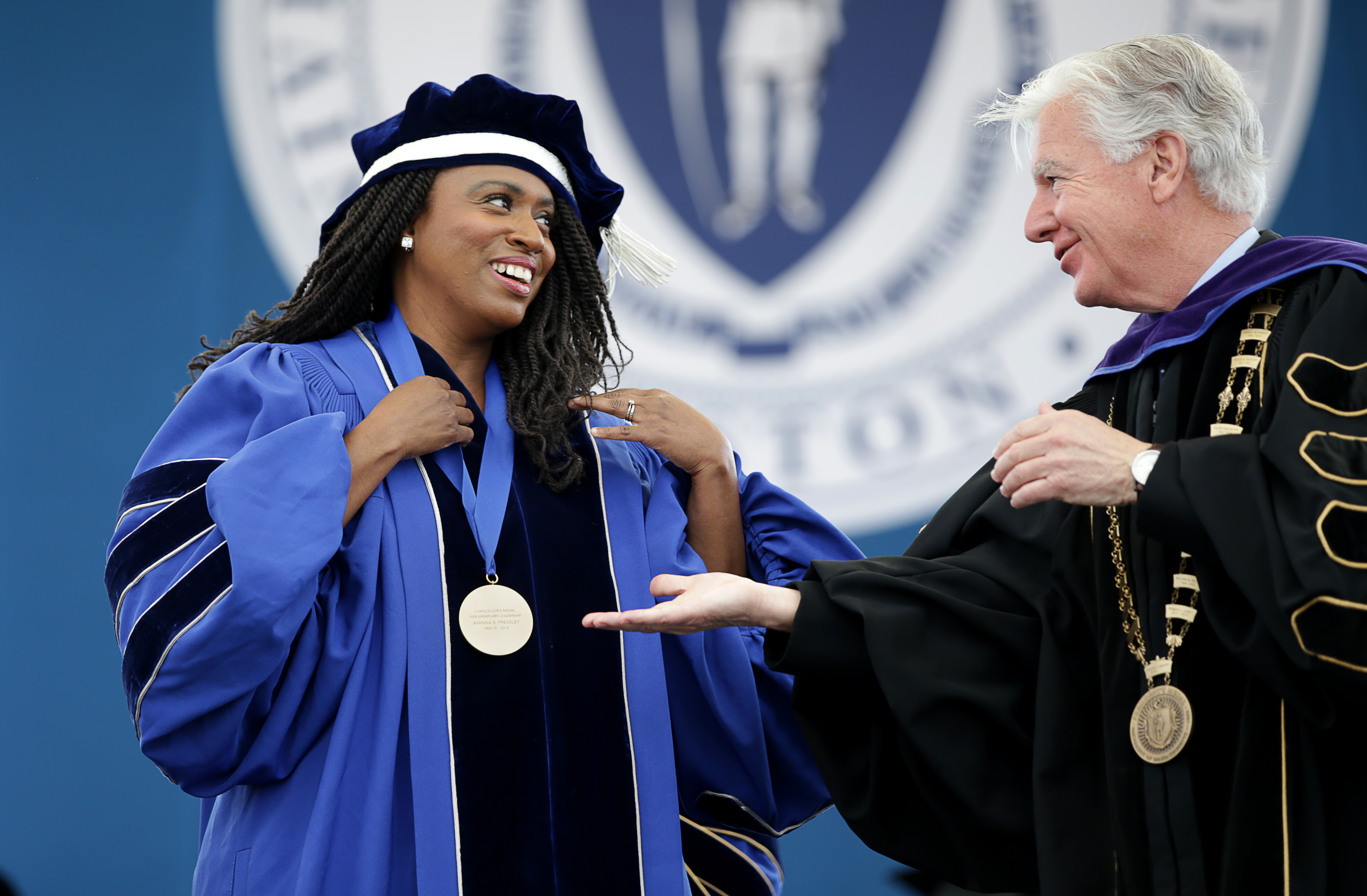 Congresswoman Ayanna Pressley (left) received the Chancellor's Medal at the University of Massachusetts Boston 2019 Commencement. Martin T. Meehan (right) is the President of the University of Massachusetts.