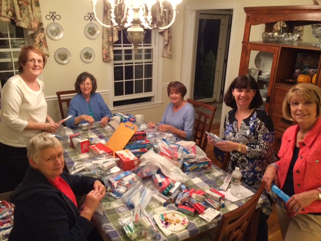 Members of the Westford Women’s Club assemble dental care packages for US troops.