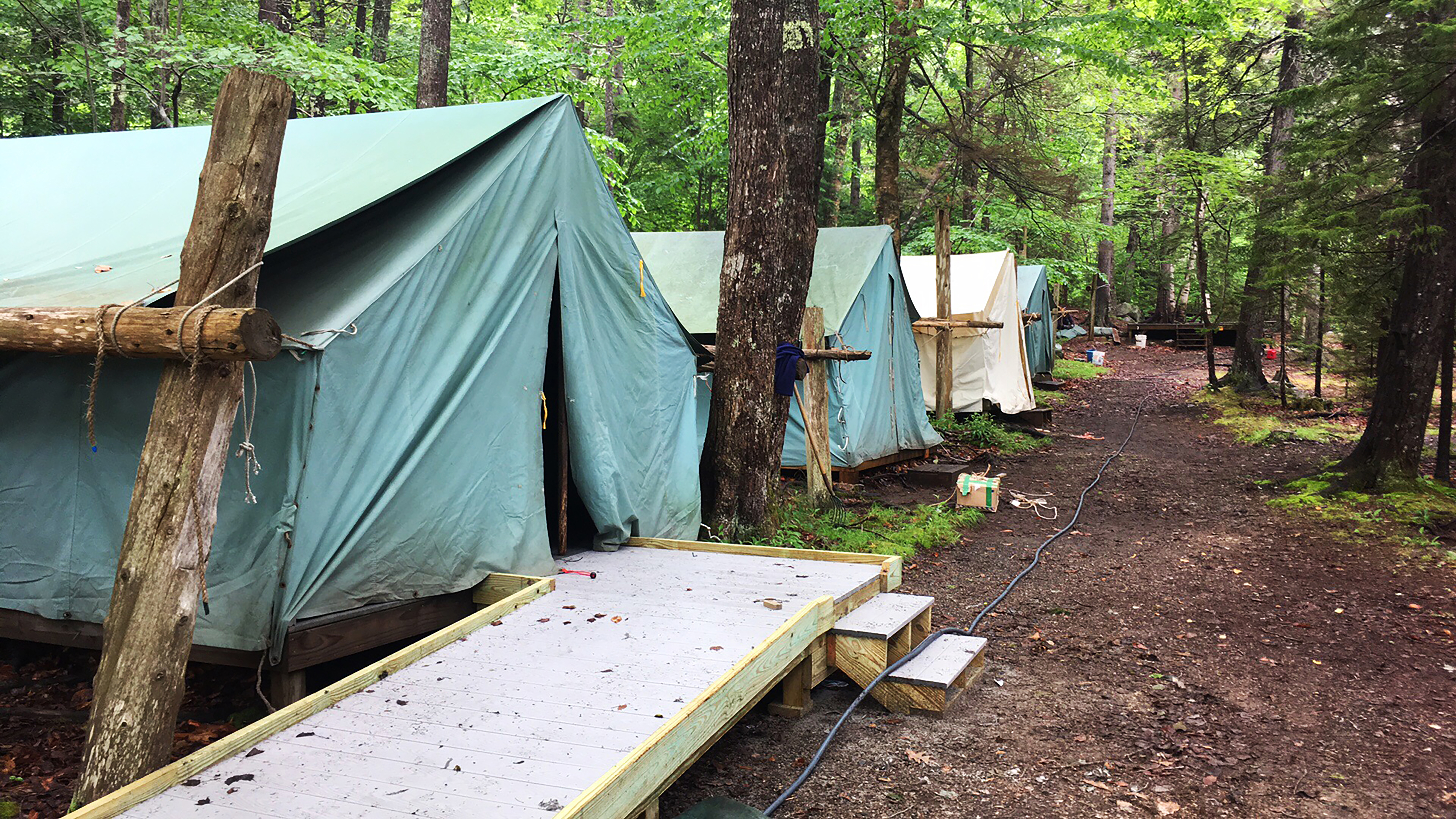 At AMC Echo Lake Camp in Mount Desert, Maine, families stay in canvas-sided platform tents with cots and mattresses.