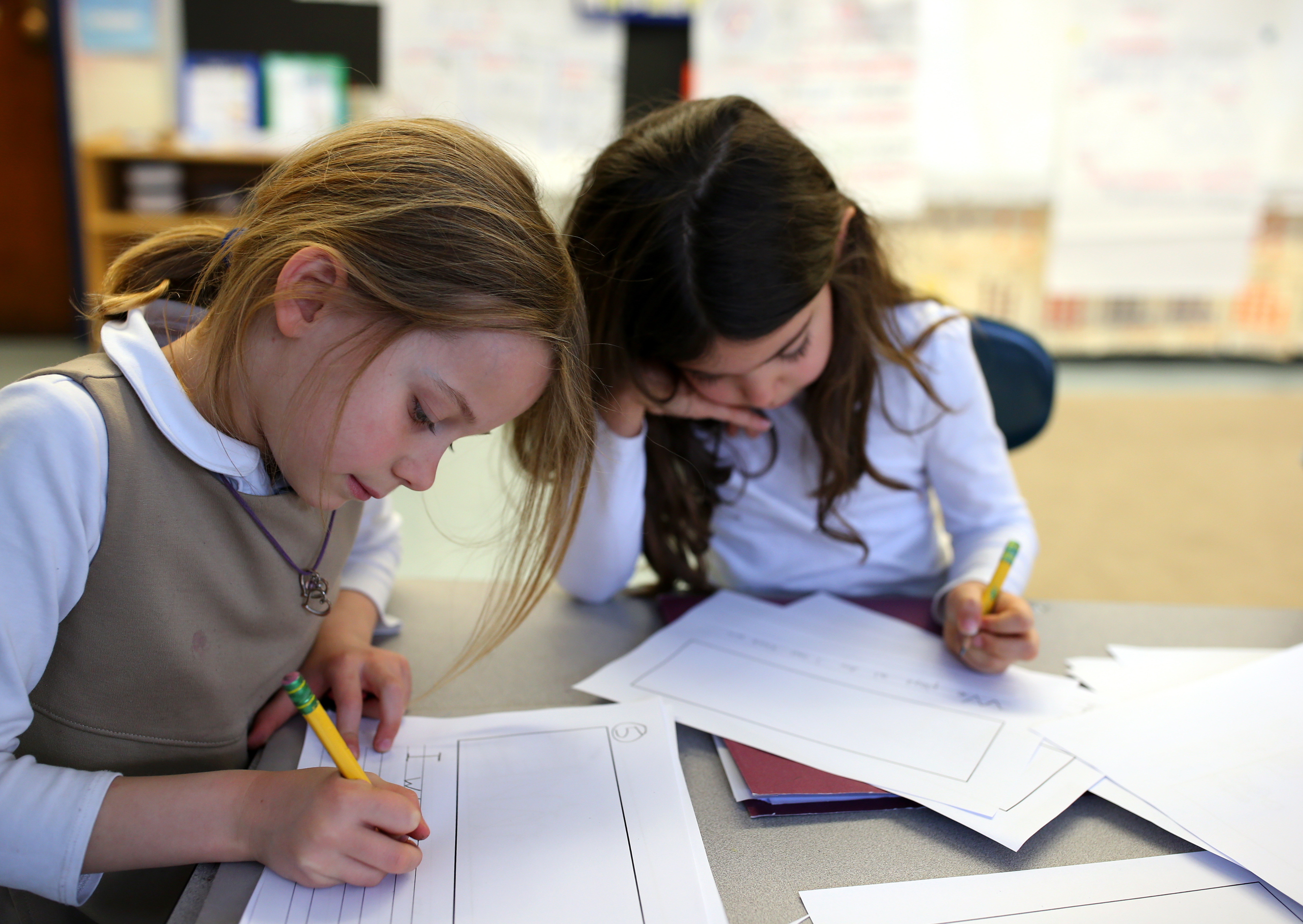 Abbie Ashburn (left) and Cristina Olmos worked in a first-grade English literacy class at the Hurley School.