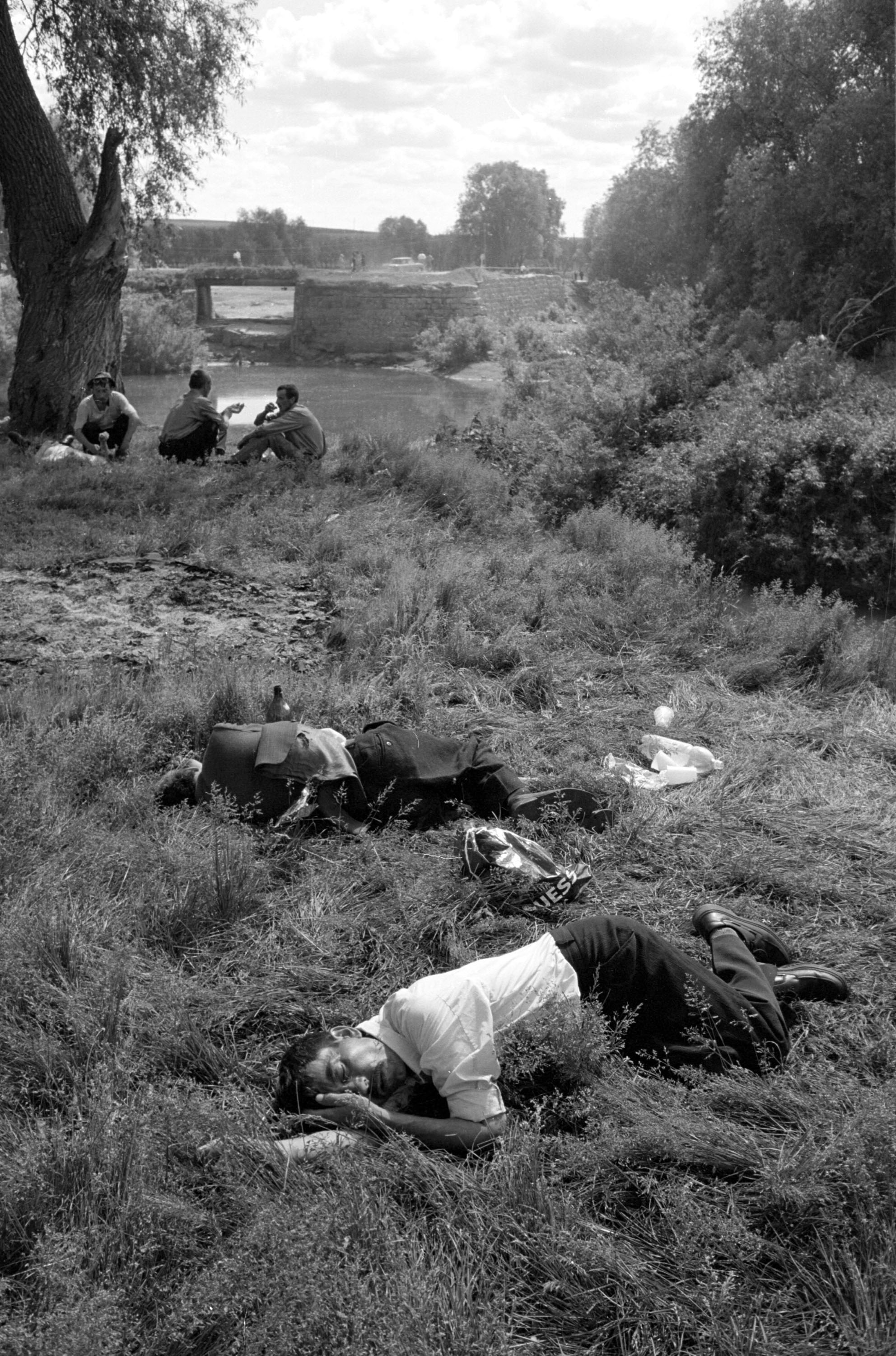 Drunk men asleep in the grass during a festival in June 2001 in the village of Baltaci, in the Tatarstan region of Russia.