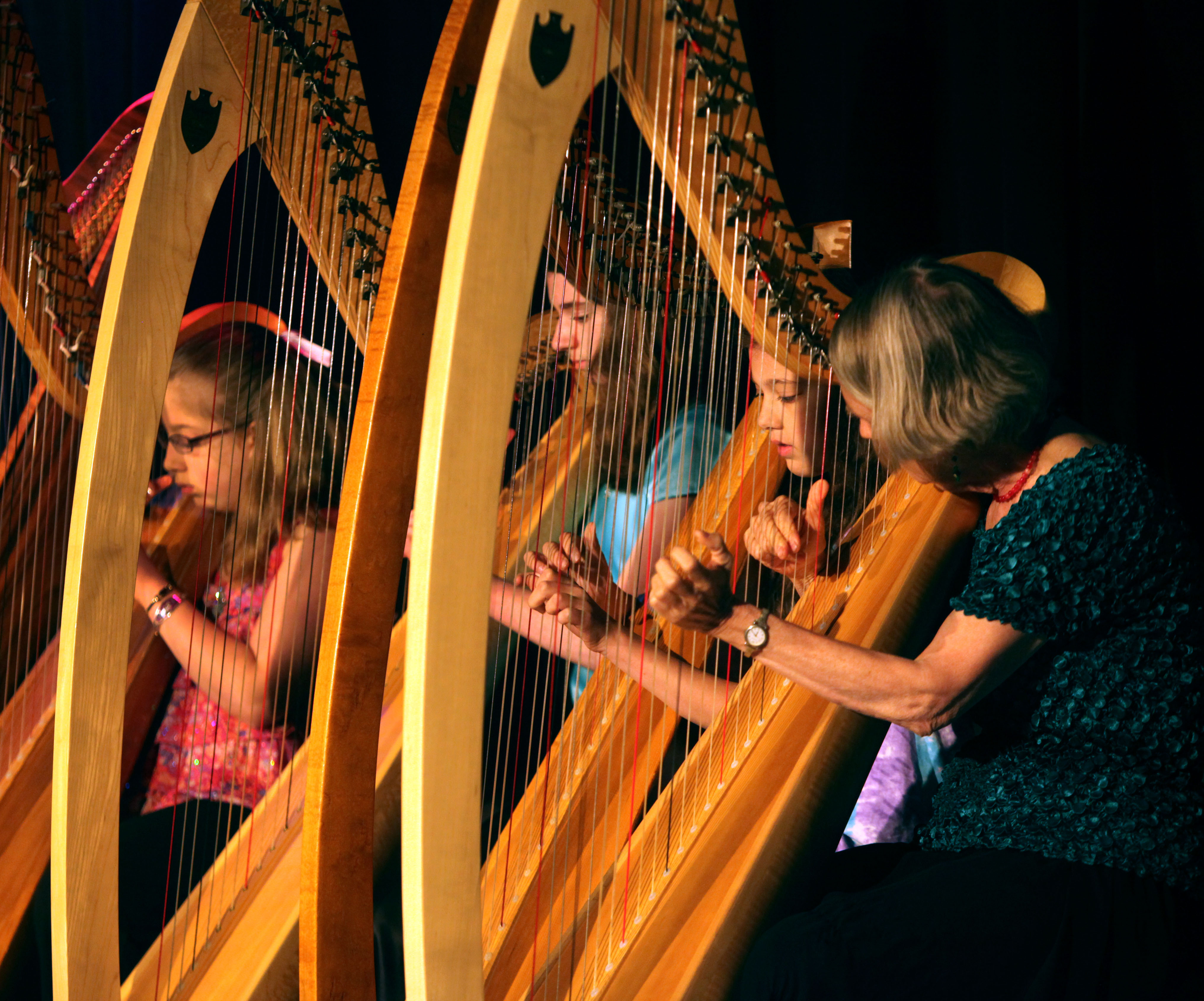 Harp students (from left) Eloise Baker, Matti Horne, Janine Owen playing a Welsh lullaby with teacher Mary- Jane Rupert.