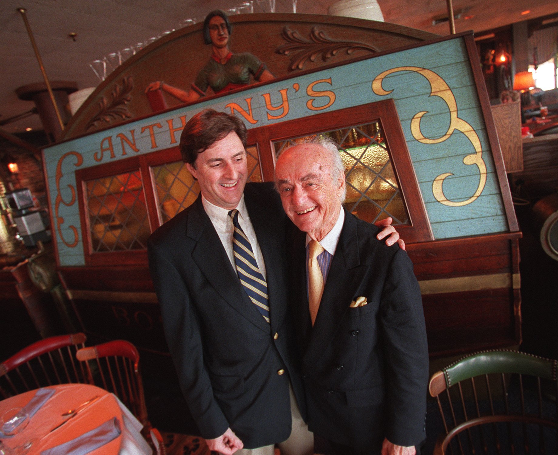 Anthony Athanas (right), the late founder of Anthony’s Pier 4 restaurant, celebrated his 89th birthday in 2000 with his son Michael.