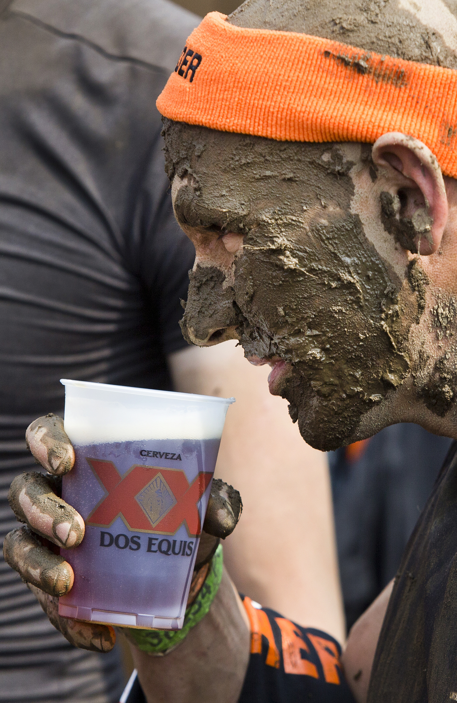 A Tough Mudder competitor gets a free beer after completing the obstacle course.