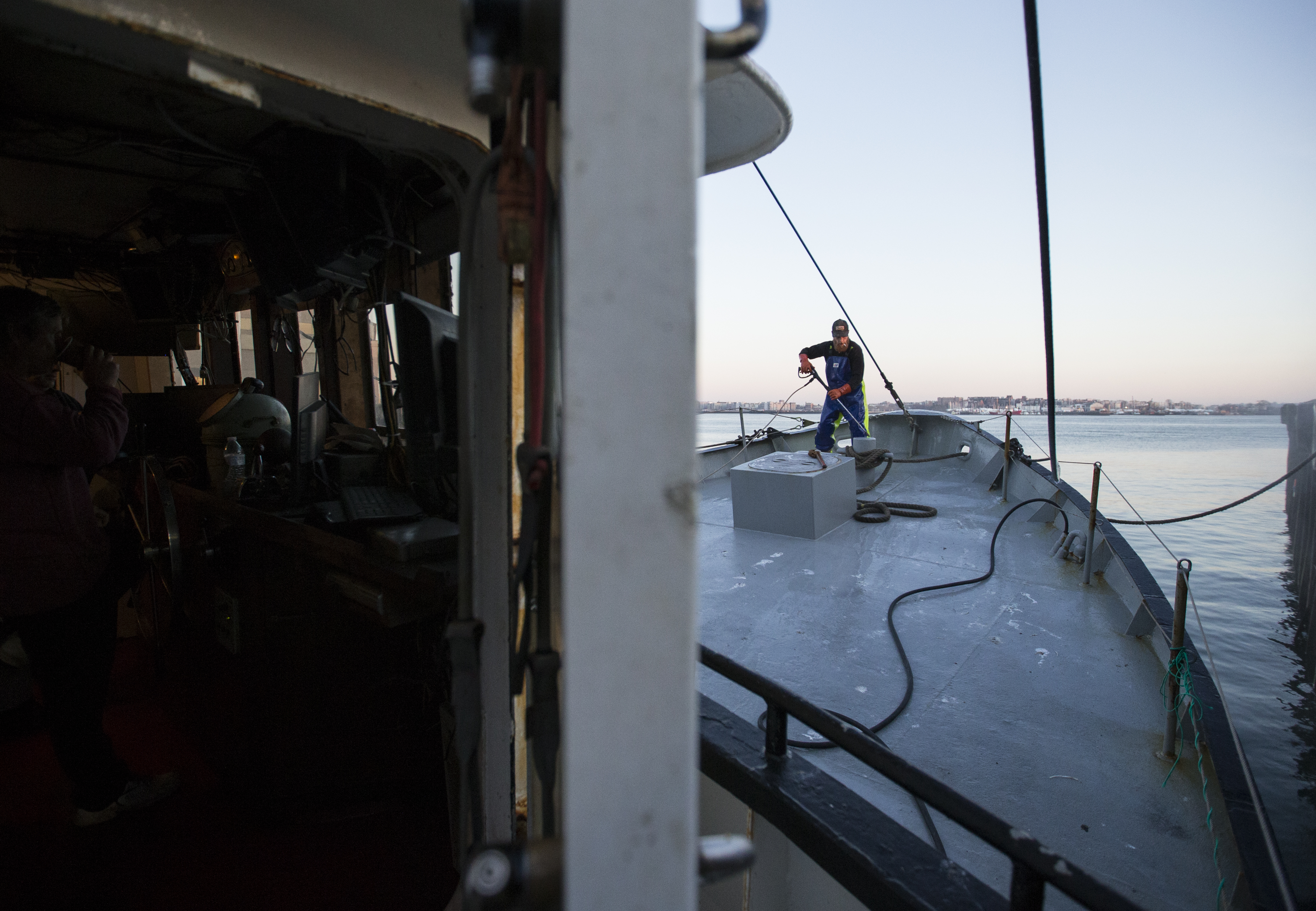 Alex Earle washed the deck of the Black Beauty at the Boston Fish Pier.