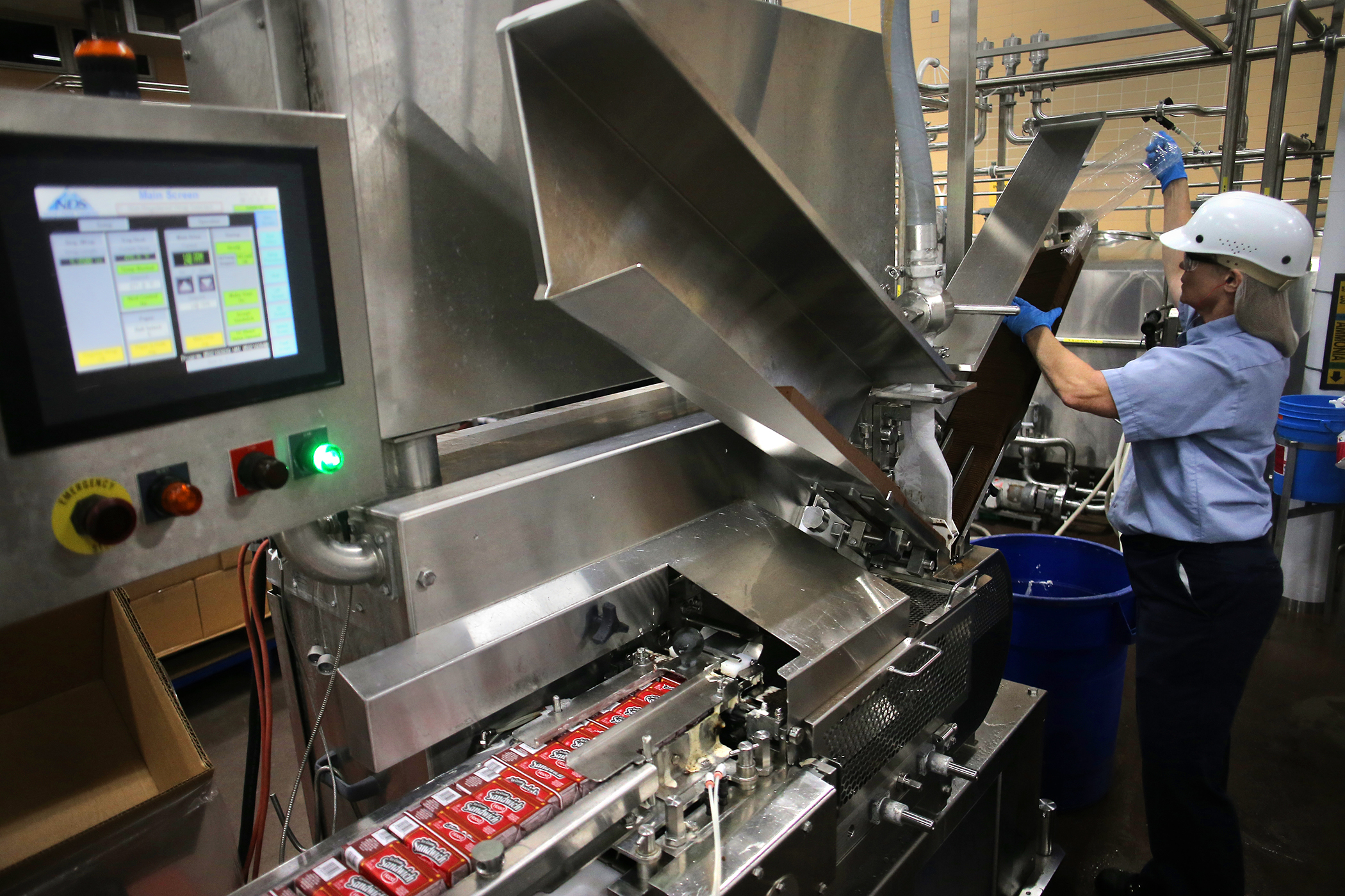 Operator Karie Jewett loaded wafers into a machine making and wrapping ice cream sandwiches.