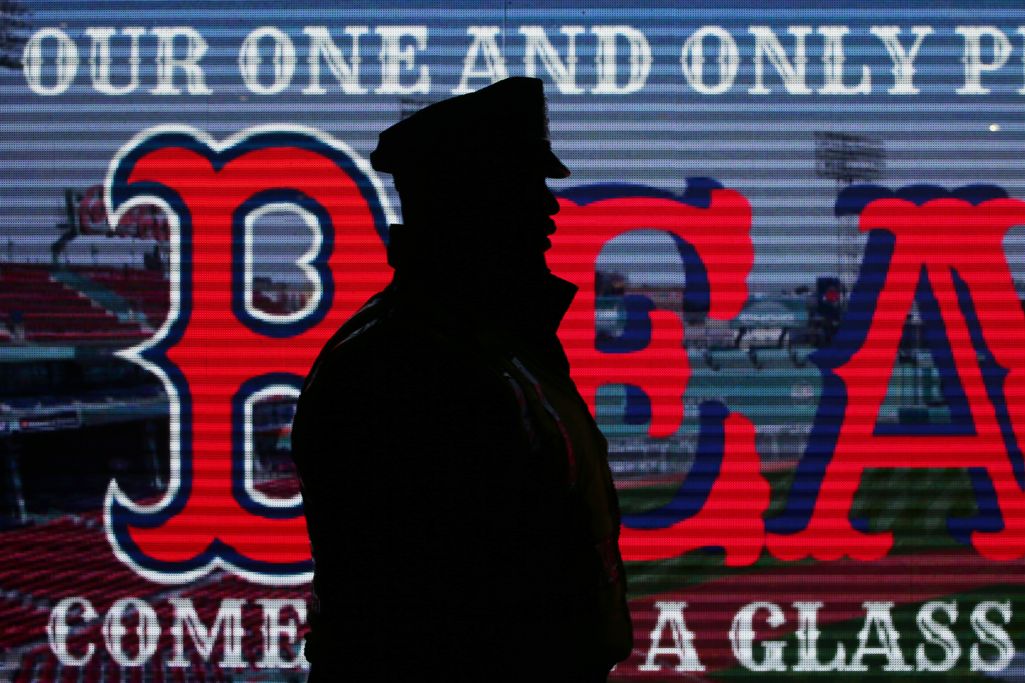A Boston Police officer walks in front of a sign outside of Fenway Park after the Red Sox won the World Series.