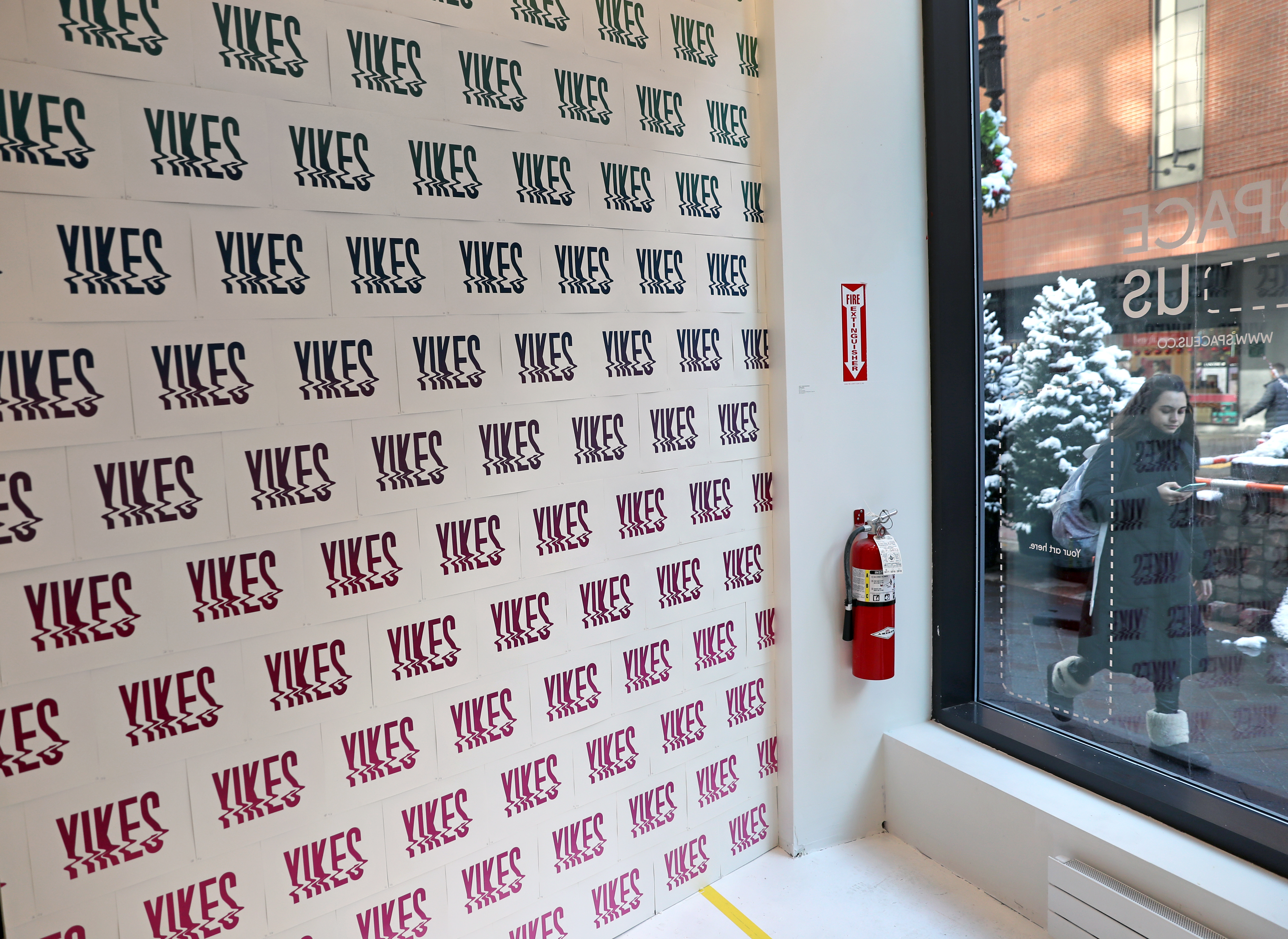A wall emblazoned with the phrase “Yikes” serves as an Instagram background at the Downtown Crossing installation.