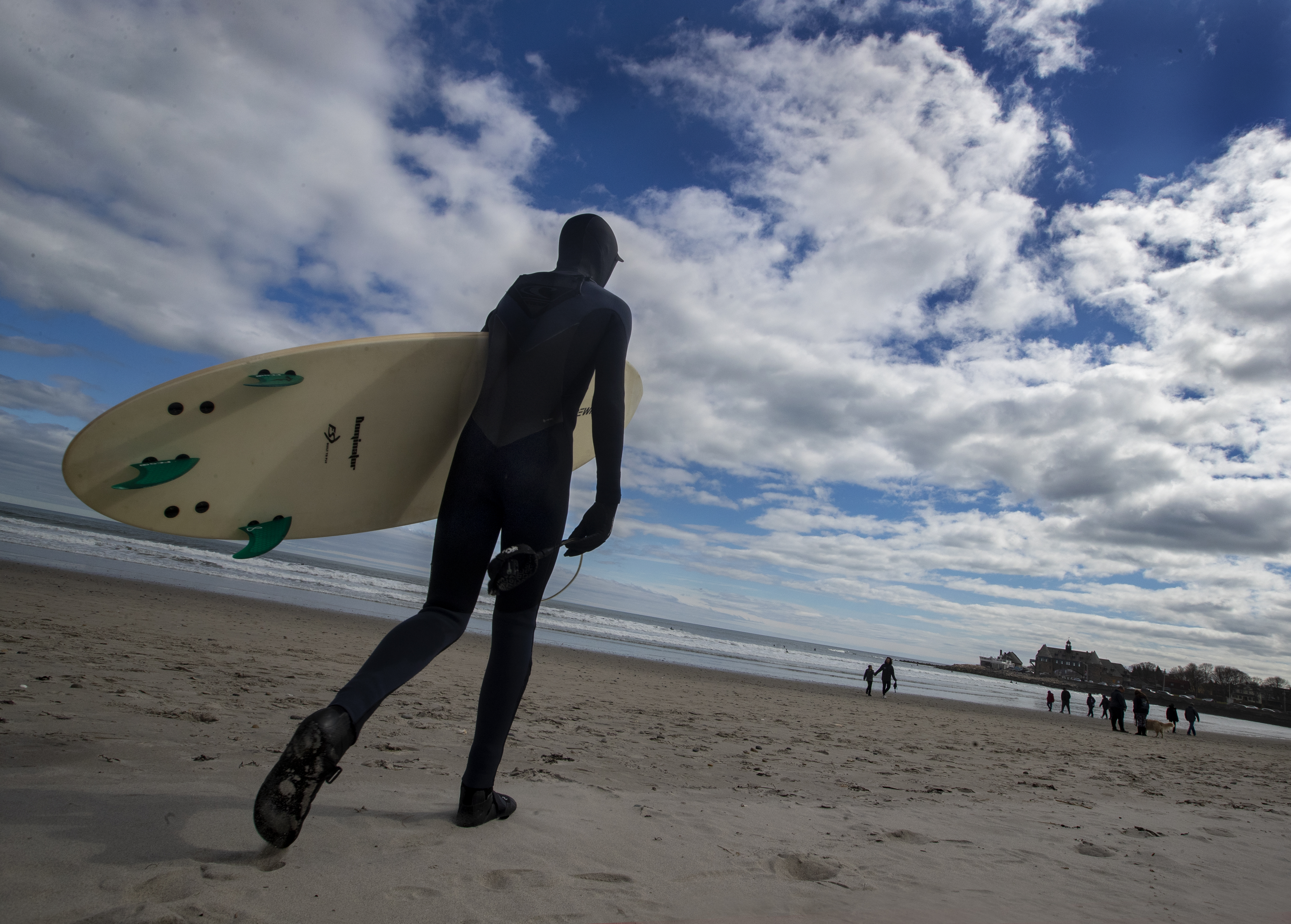 Clad in wetsuits to combat spring water temperatures in the mid-40s, surfers prepare to paddle out at Narragansett Beach, just off the opening of Narragansett Bay.