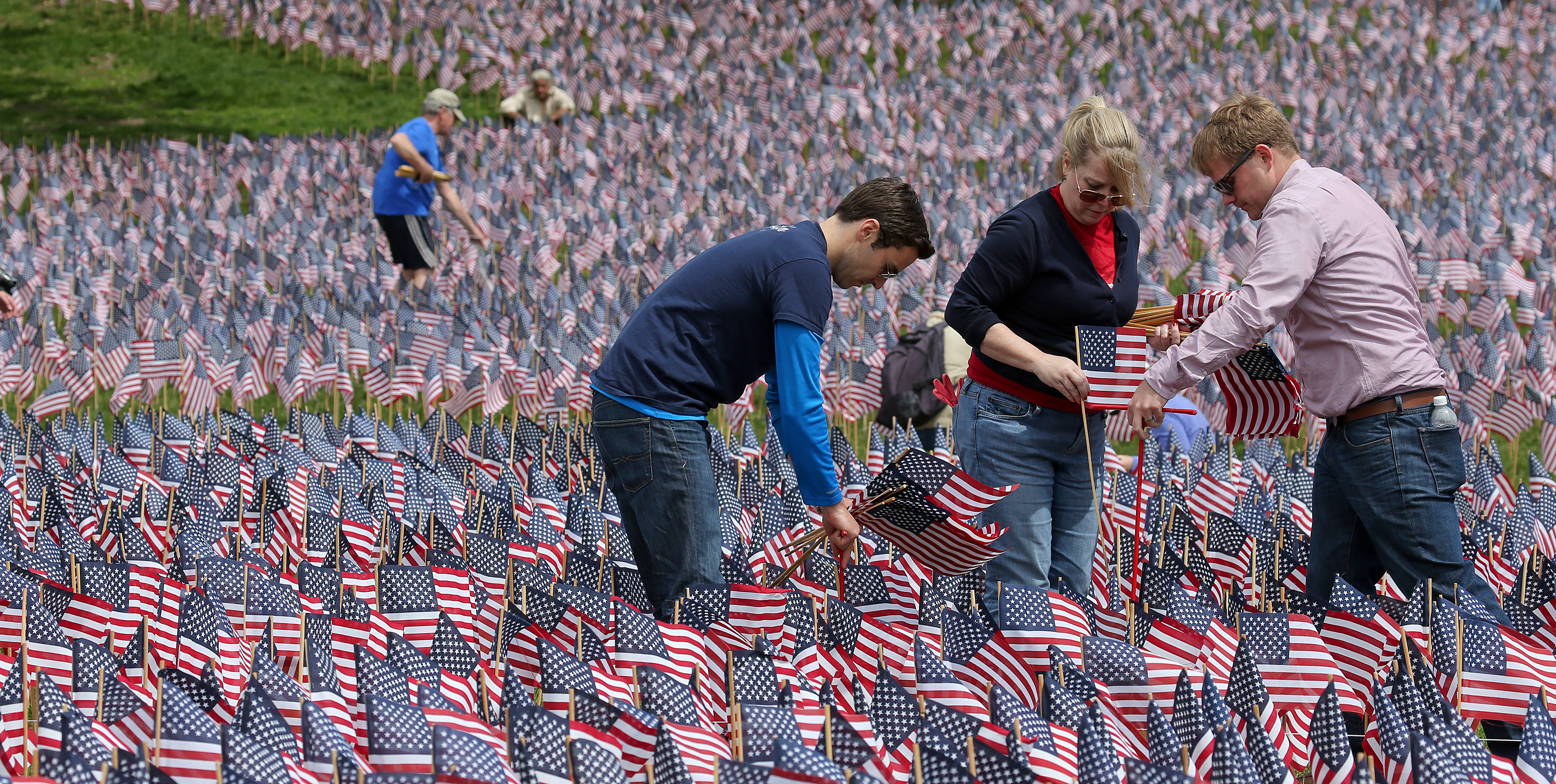 Volunteers began placing flags in Boston Common on Wednesday ahead of Memorial Day. They plan to put in nearly 37,000 flags.