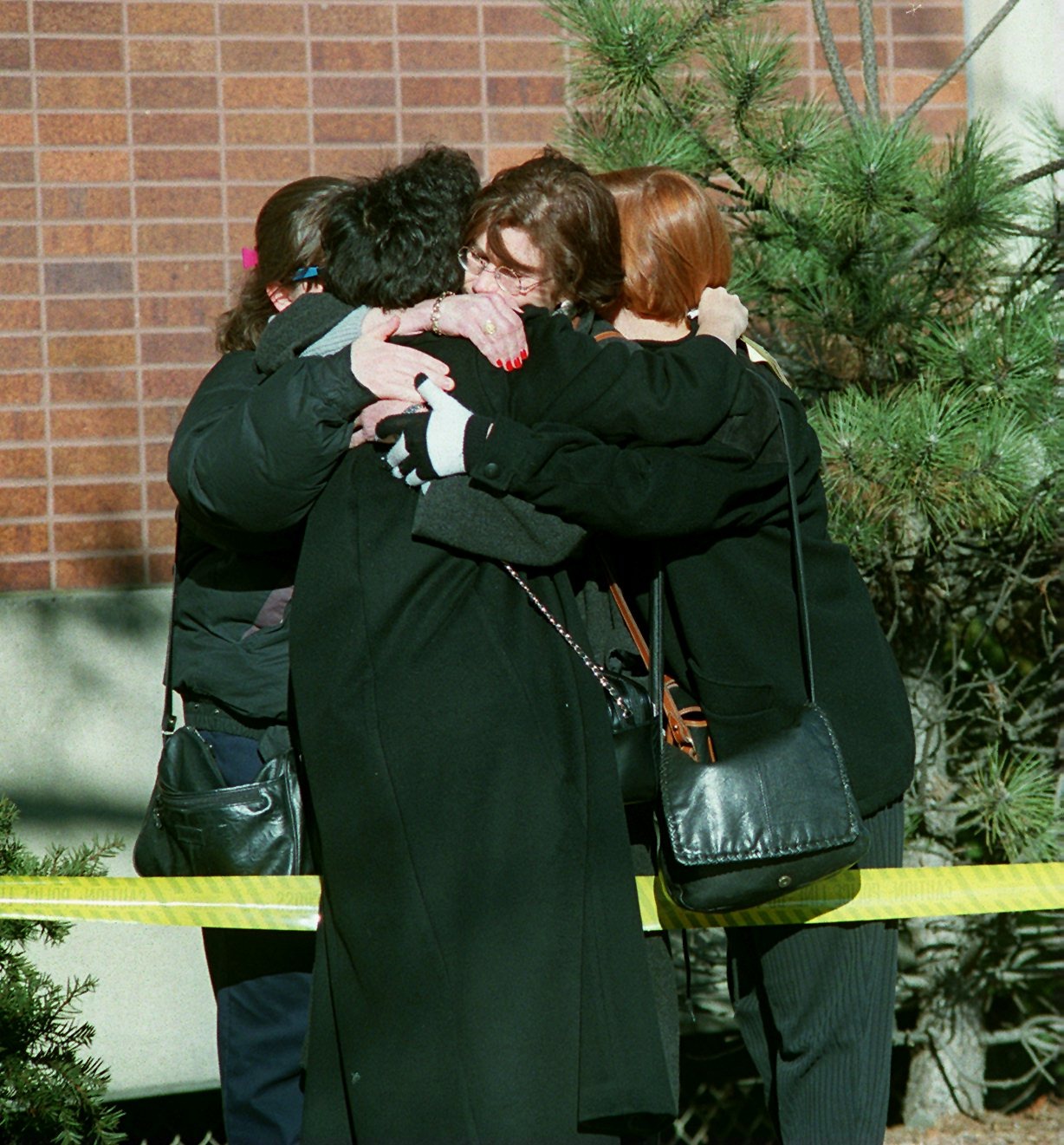 Women consoled each other after a shooting at the Brookline clinic.