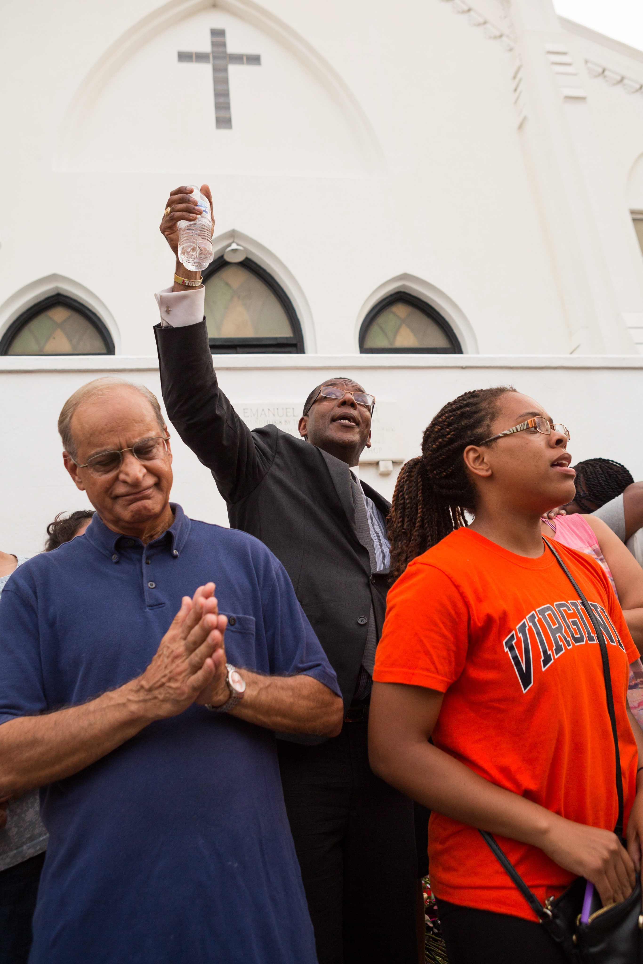 Charleston residents gathered and sung together outside the historic Emanuel African Methodist Episcopal Church on Friday to honor the nine victims slain by alleged killer Dylann Roof.