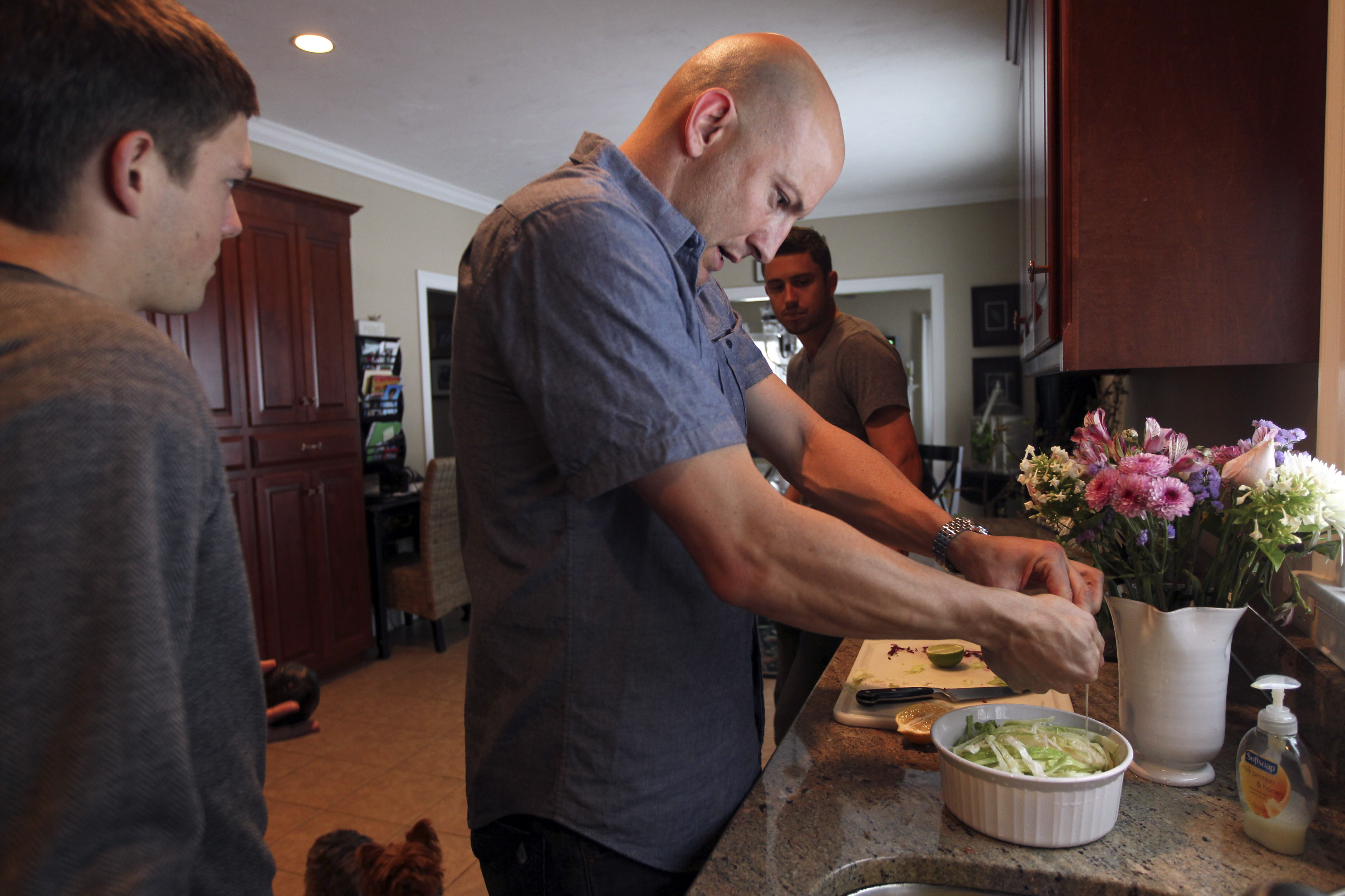 Kelyn Rowe (left), Matt Reis (center) and Chris Tierney prepared a meal.