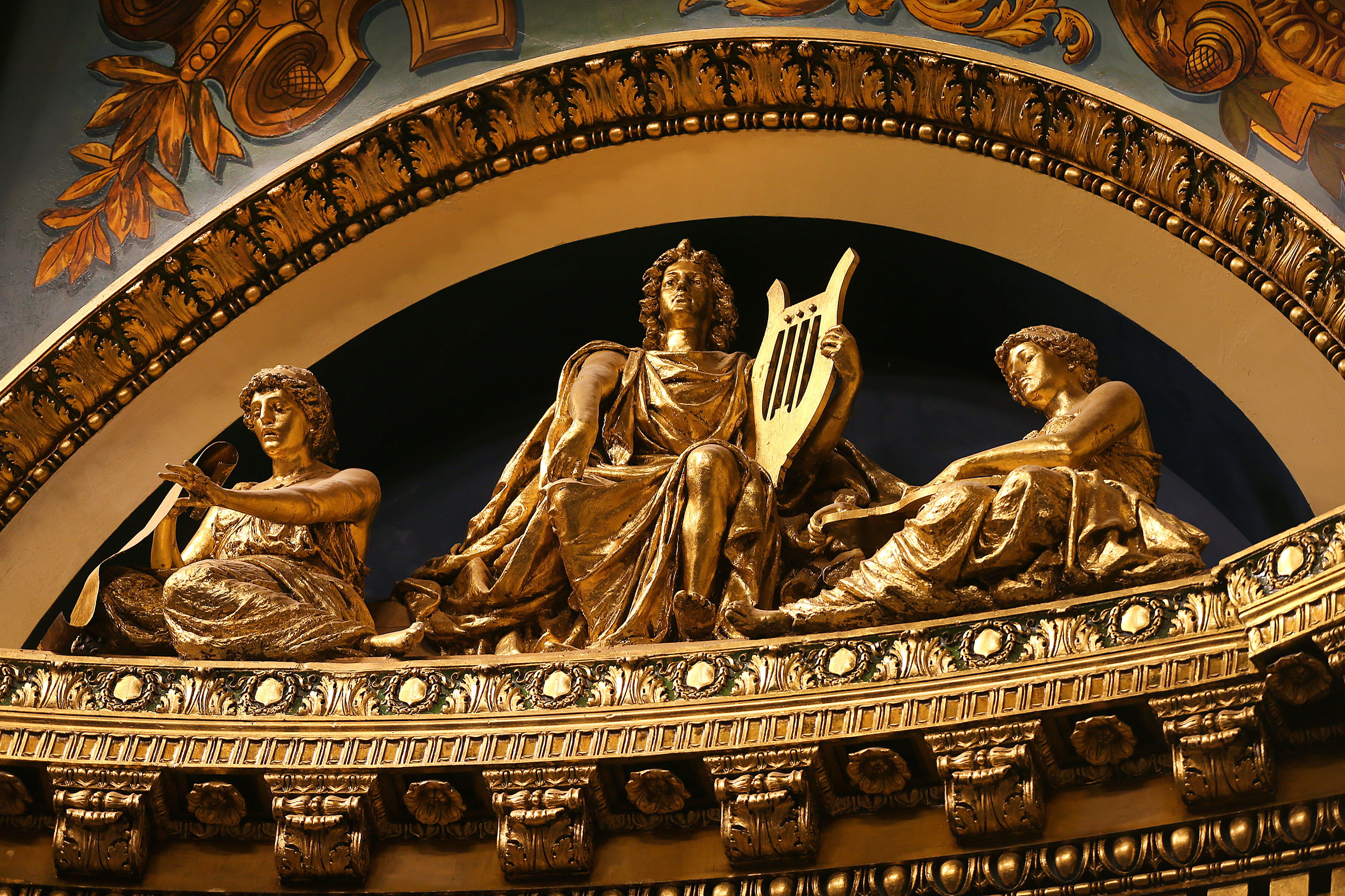 Figures high above the side of the stage.