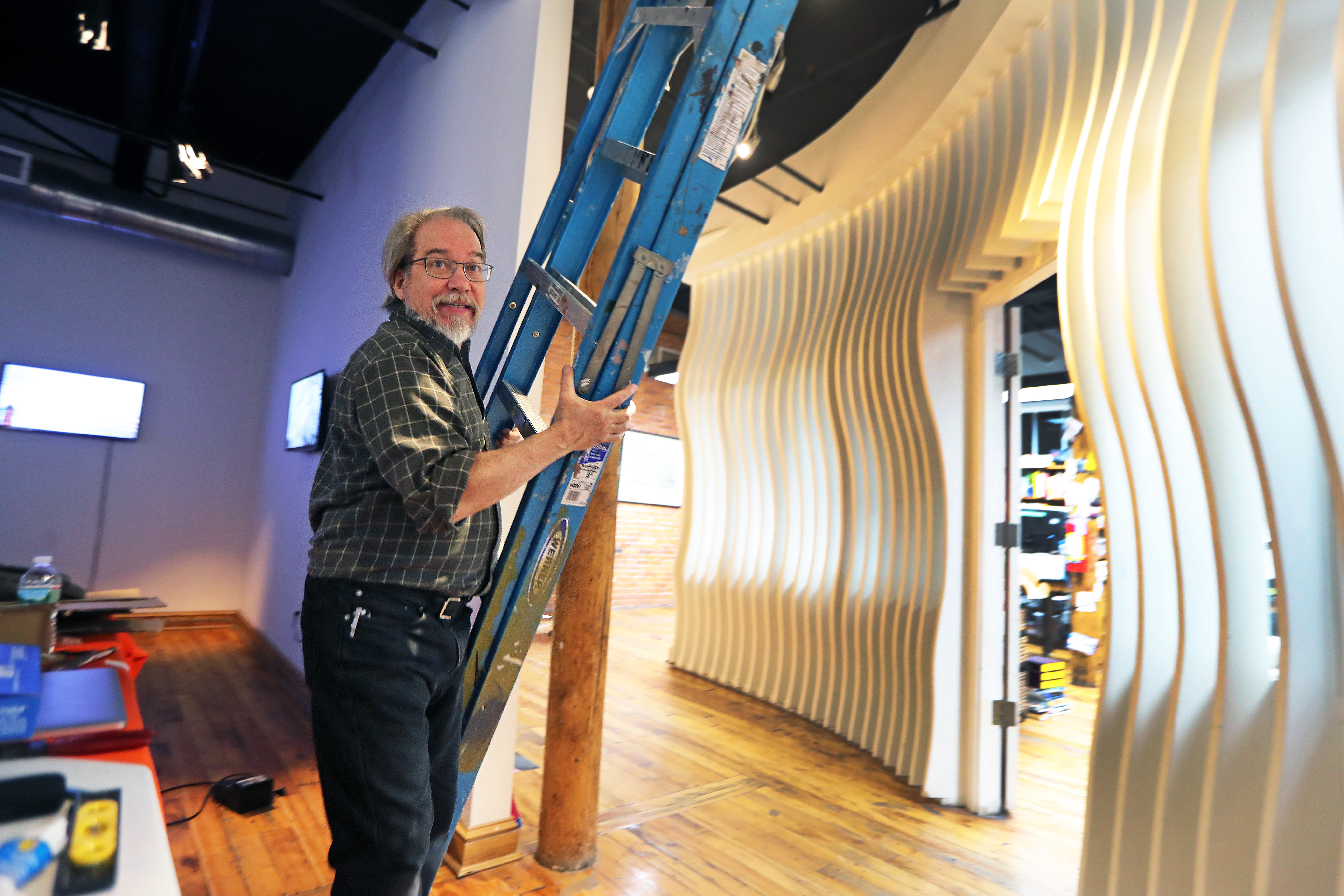 Dennis Hlynsky adjusted the lighting on his video installation about crows at the Essex Art Center.