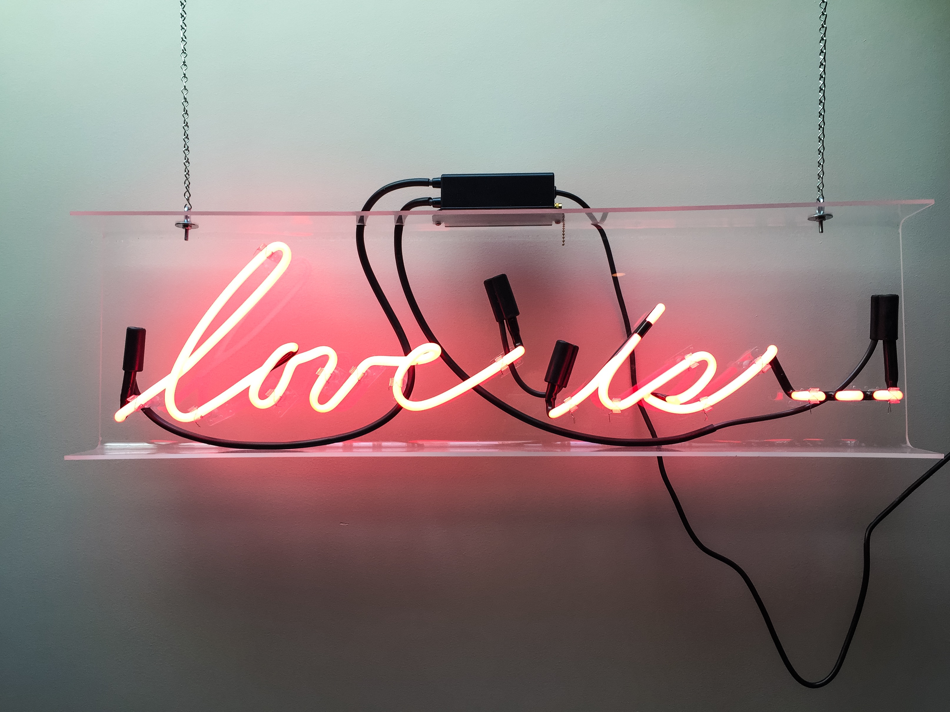 A neon sign in a hallway at the hotel.