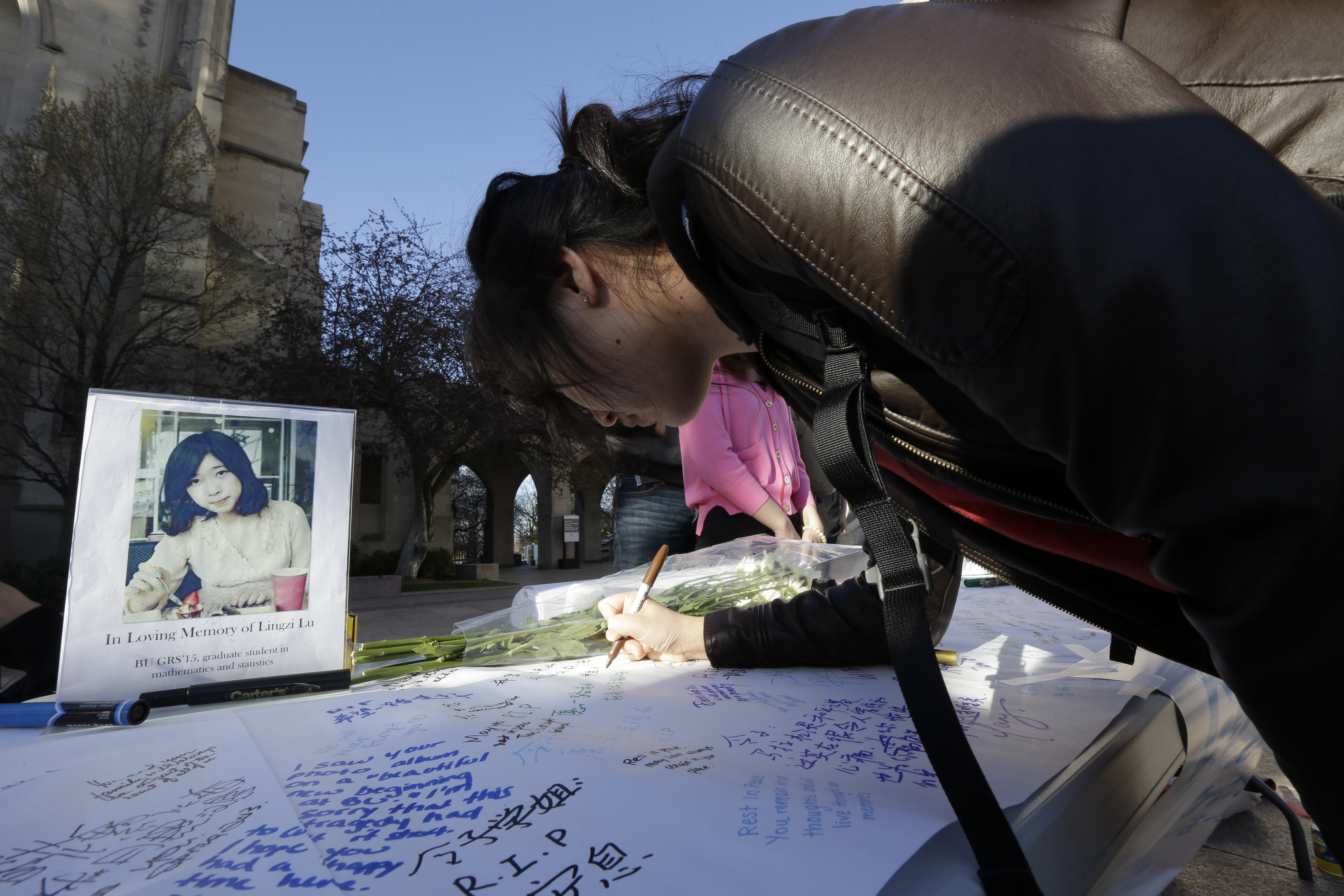 A photograph of Boston University graduate student Lingzi Lu sat next to a message board outside the school’s Marsh Chapel on Wednesday.