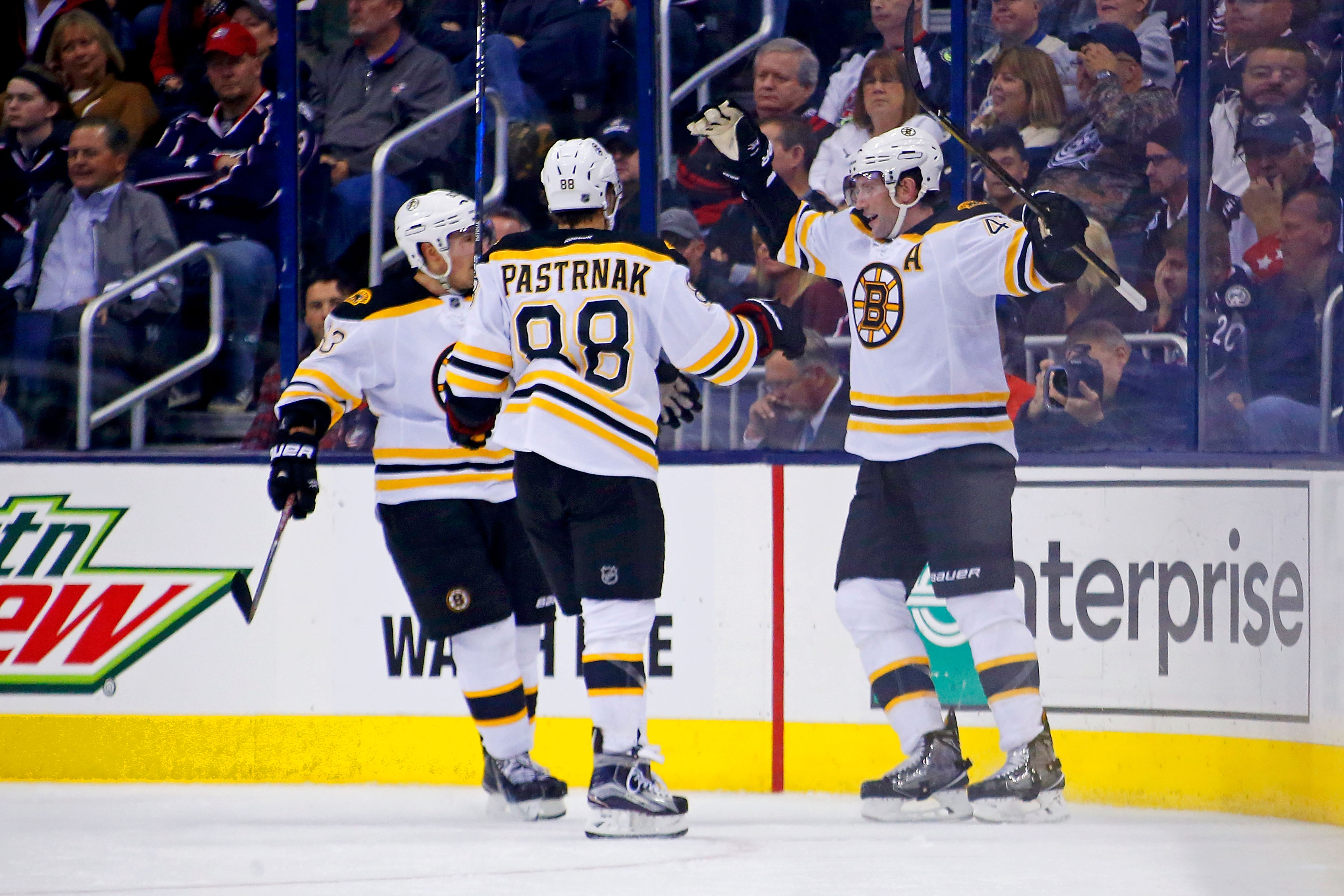 David Backes (right) is congratulated by David Pastrnak (center) and Brad Marchand after scoring in the second period against the Blue Jackets on Oct. 13.