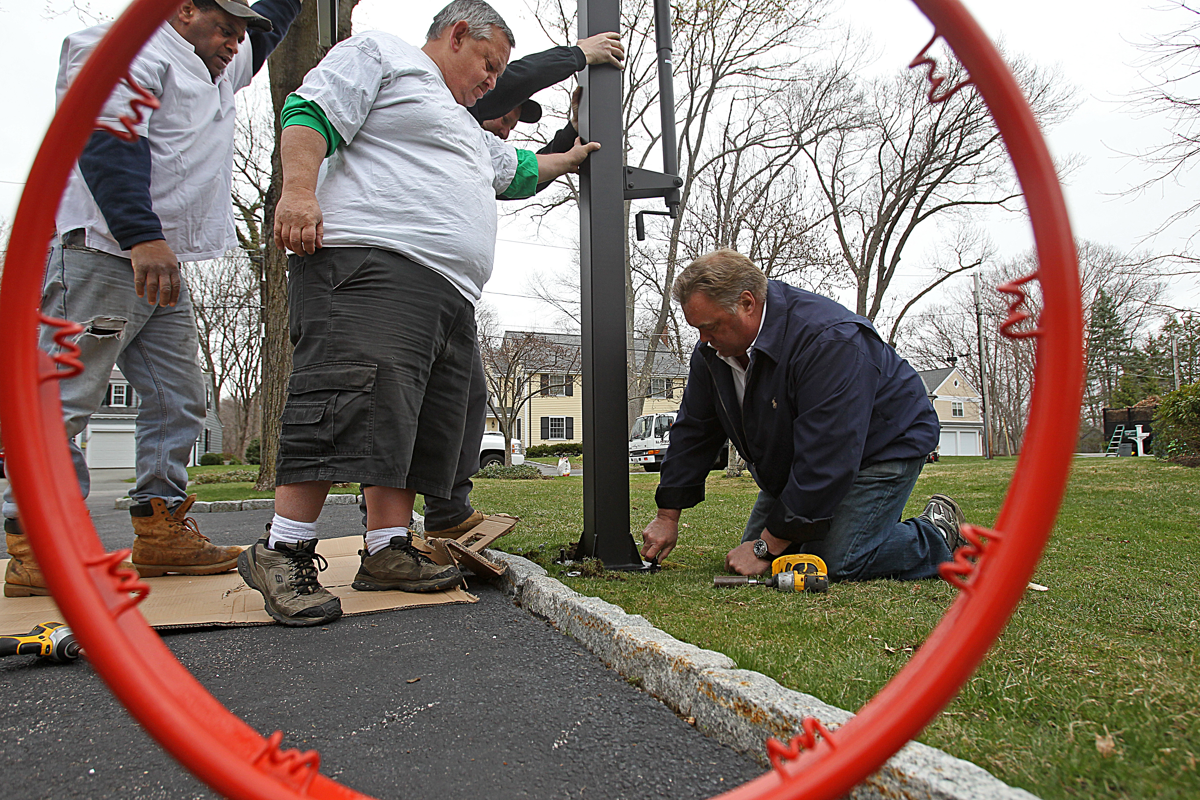 Mr. Hoop employees, including the owner, Eric Elofson (far right), work on an installation.
