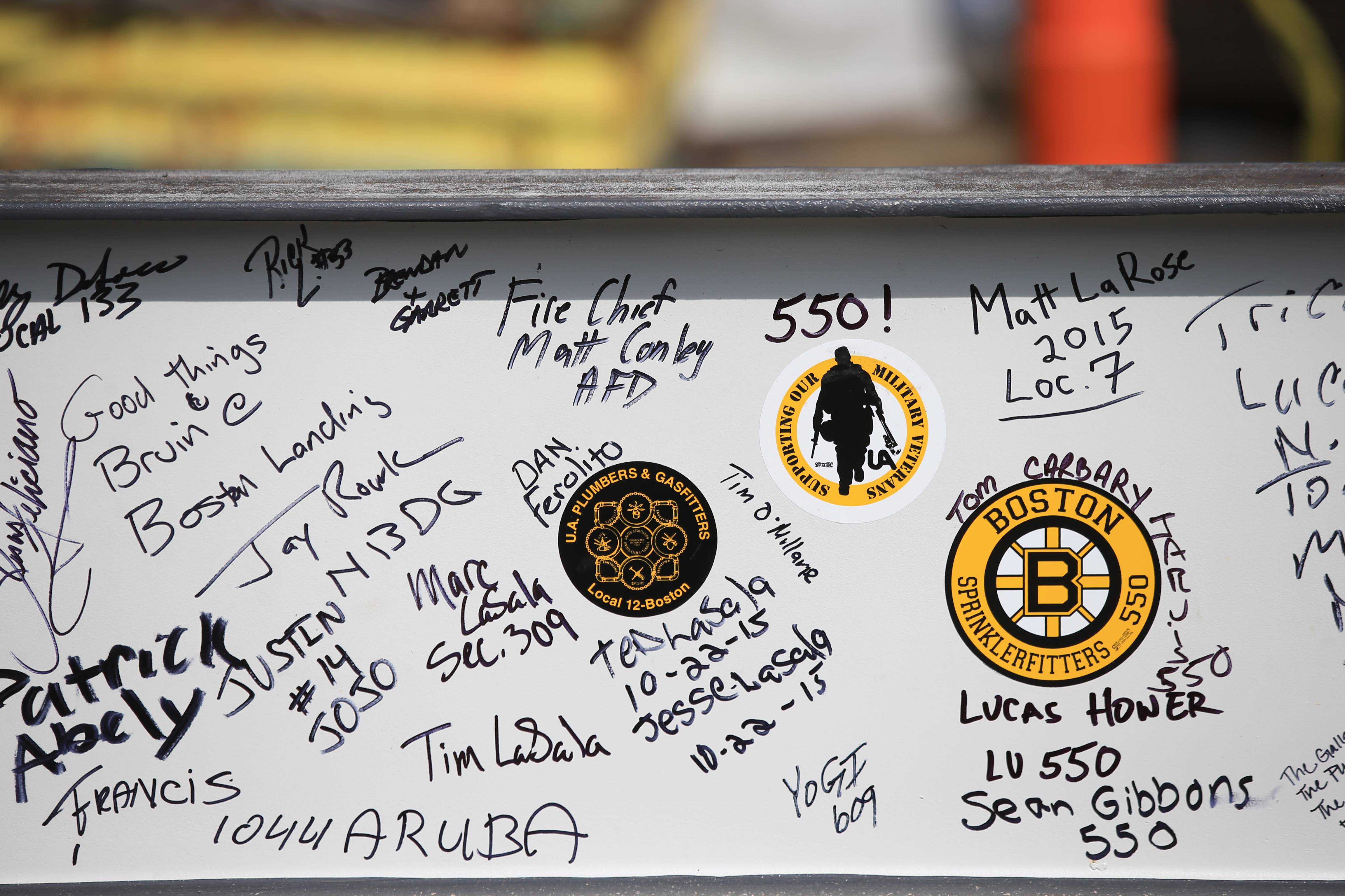 Mayor Martin J. Walsh, Cam Neely, the construction workers, and others signed two of the steel beams before they were lifted at the Warrior Ice Arena.