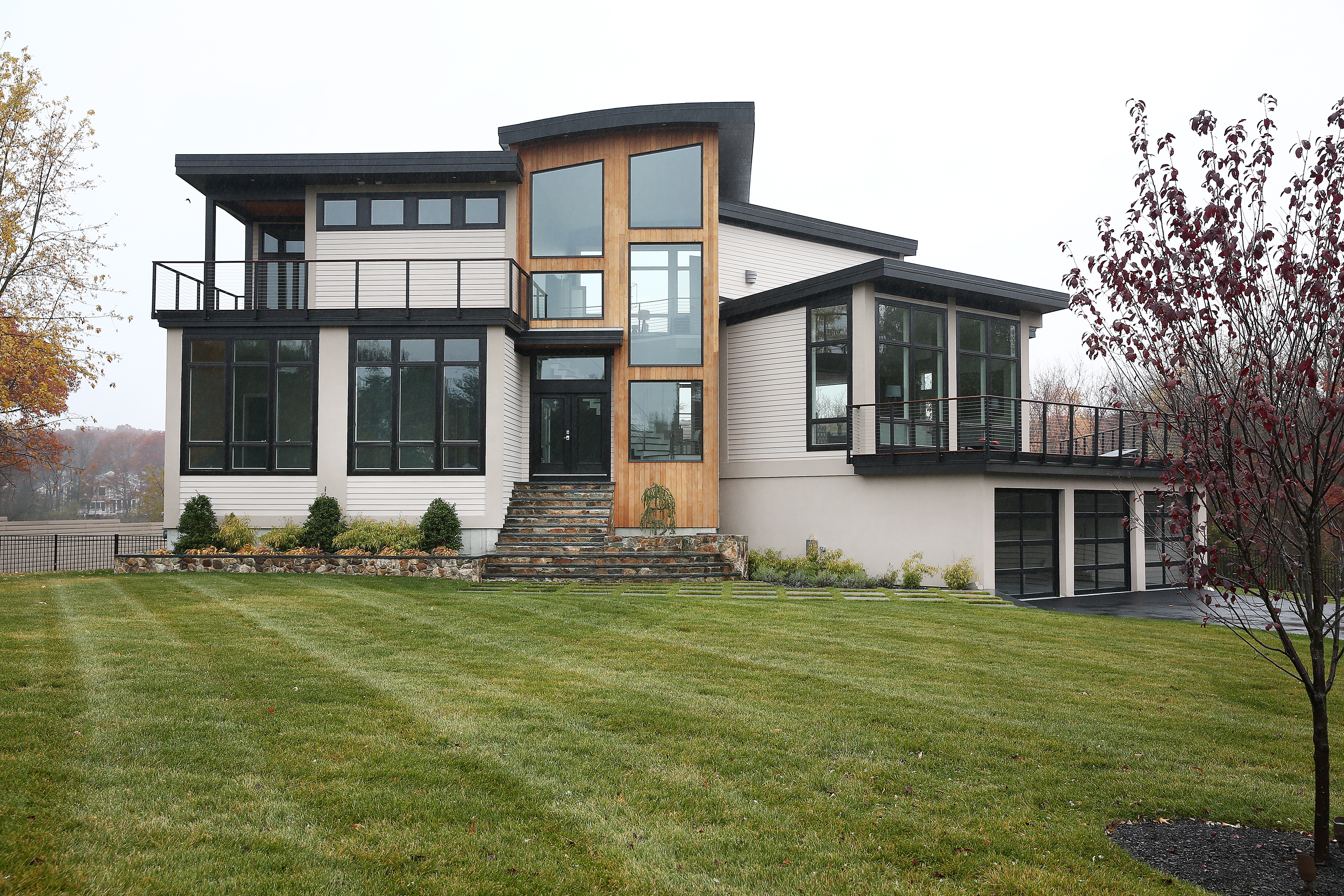 The 7,200-square-foot contemporary home offers five bedrooms, four in a first-floor wing.