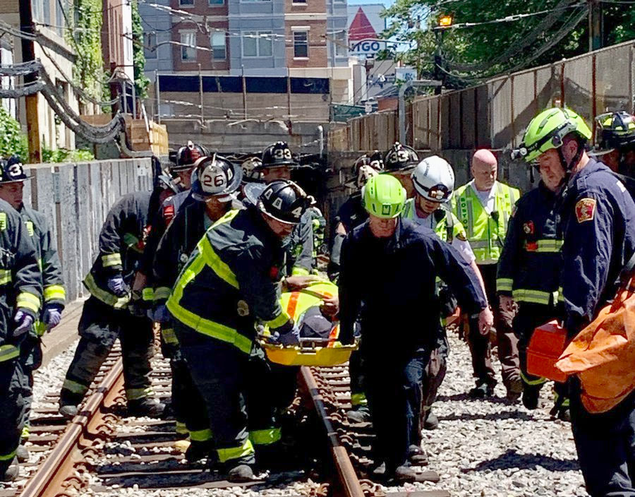 Firefighters carried an injured person from a tunnel after a derailment in Boston on Saturday.