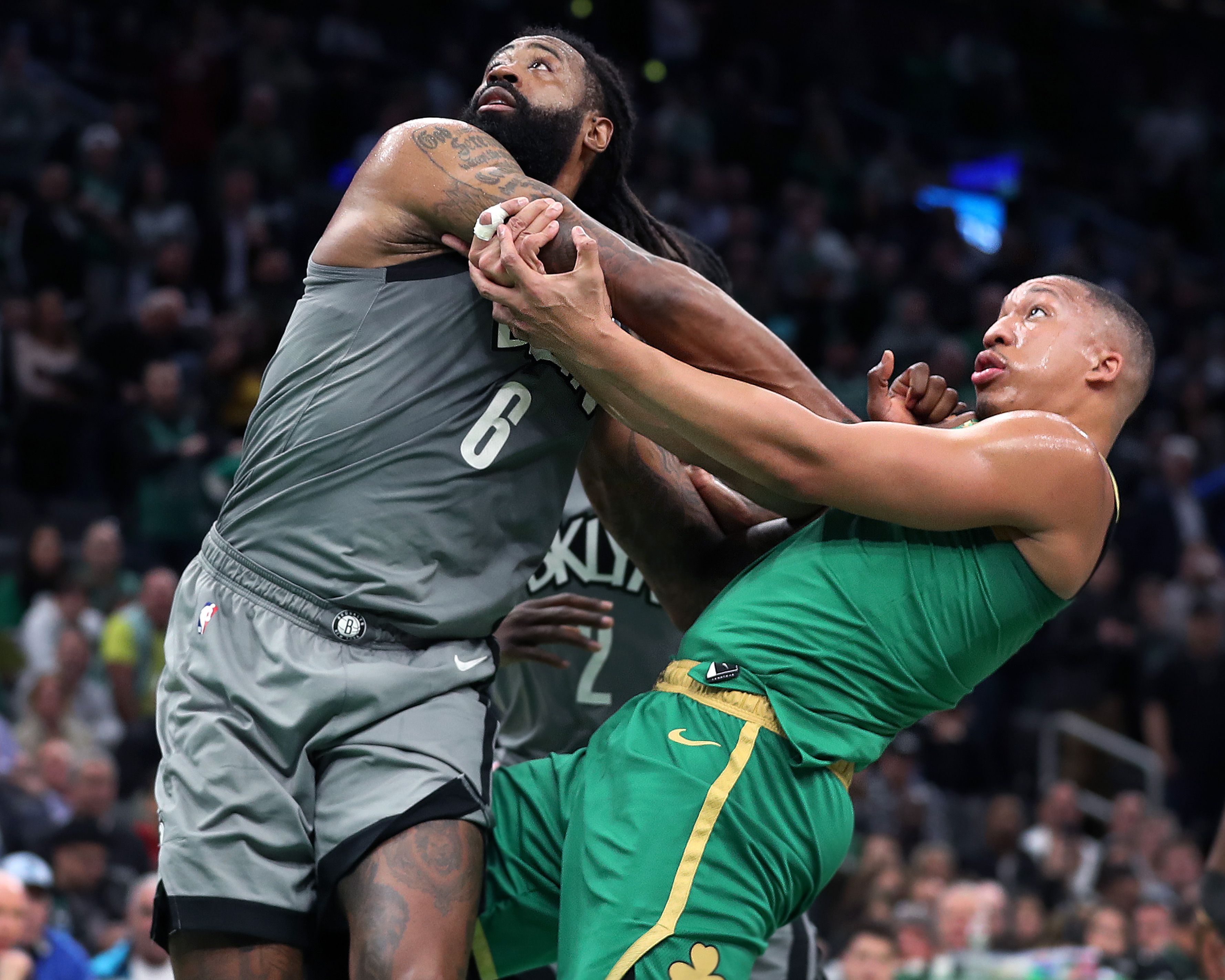 The Nets’ DeAndre Jordan (left) gets the best of Grant Williams as they battle for position in the fourth quarter.