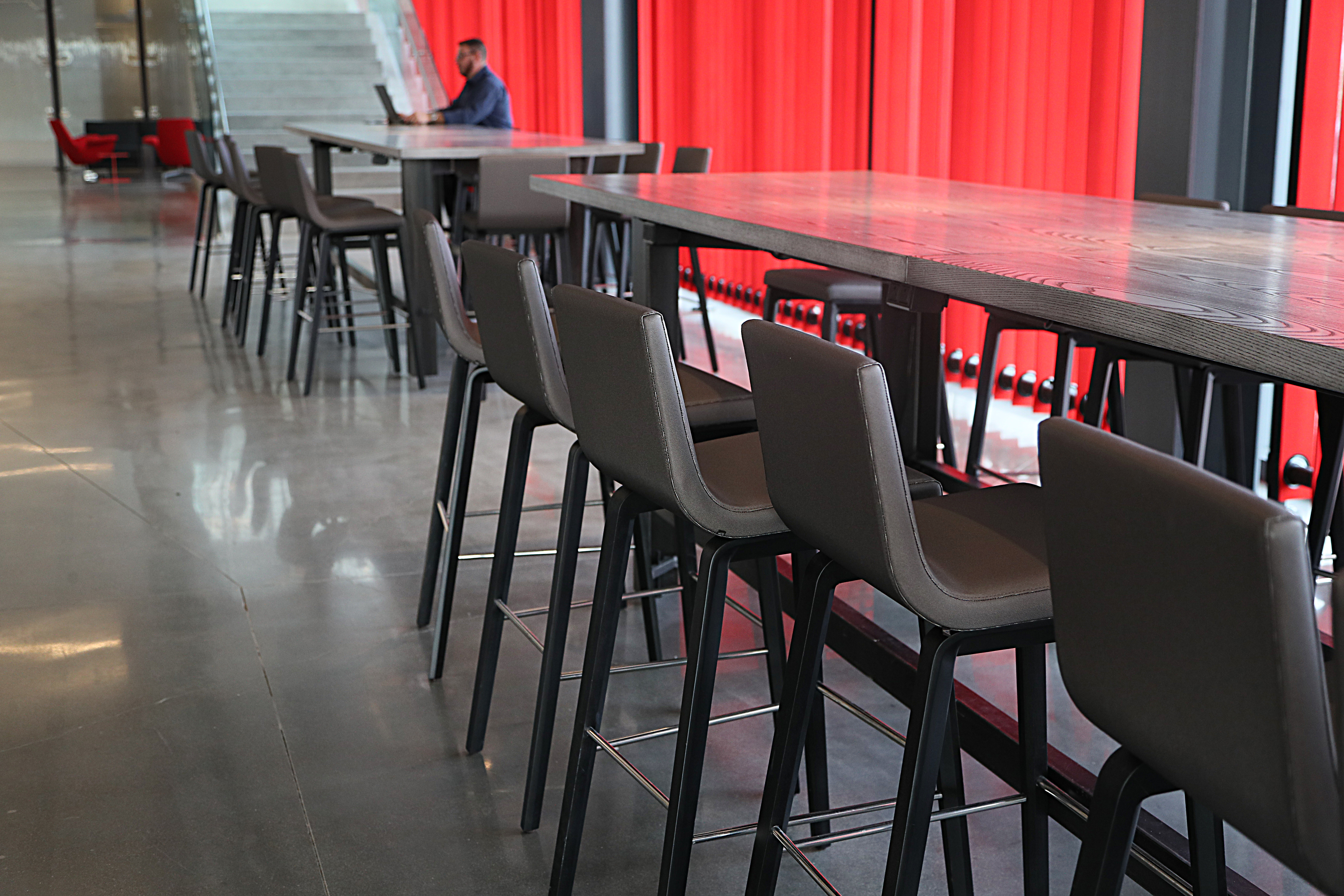 New office space at Suffolk Construction includes open, shared seating in the cafeteria to help promote more face-to-face interaction among employees who may work in isolation.