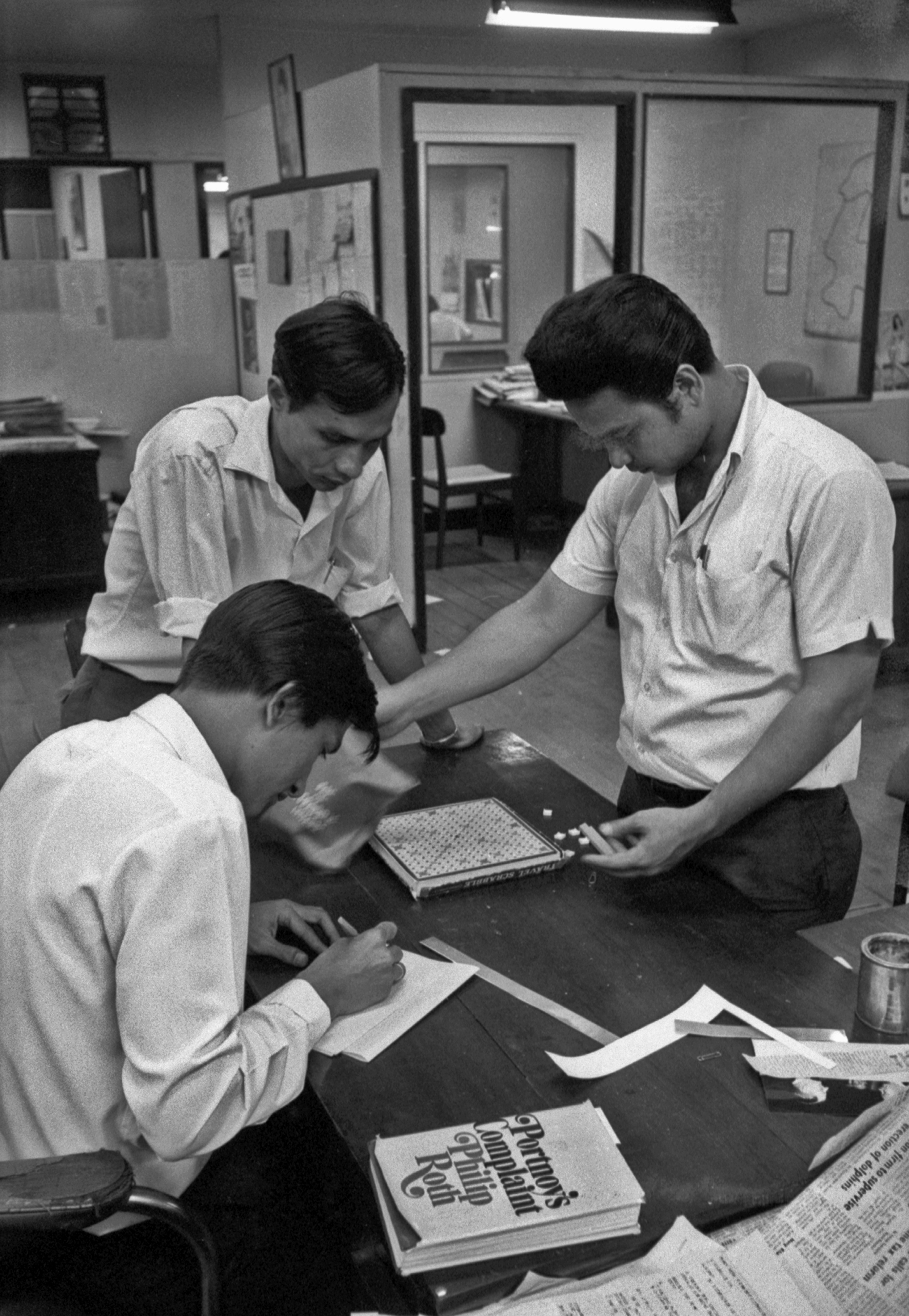 Copy editors at the Bangkok World in Bangkok, Thailand, play Scrabble after deadline in the late 1960s.