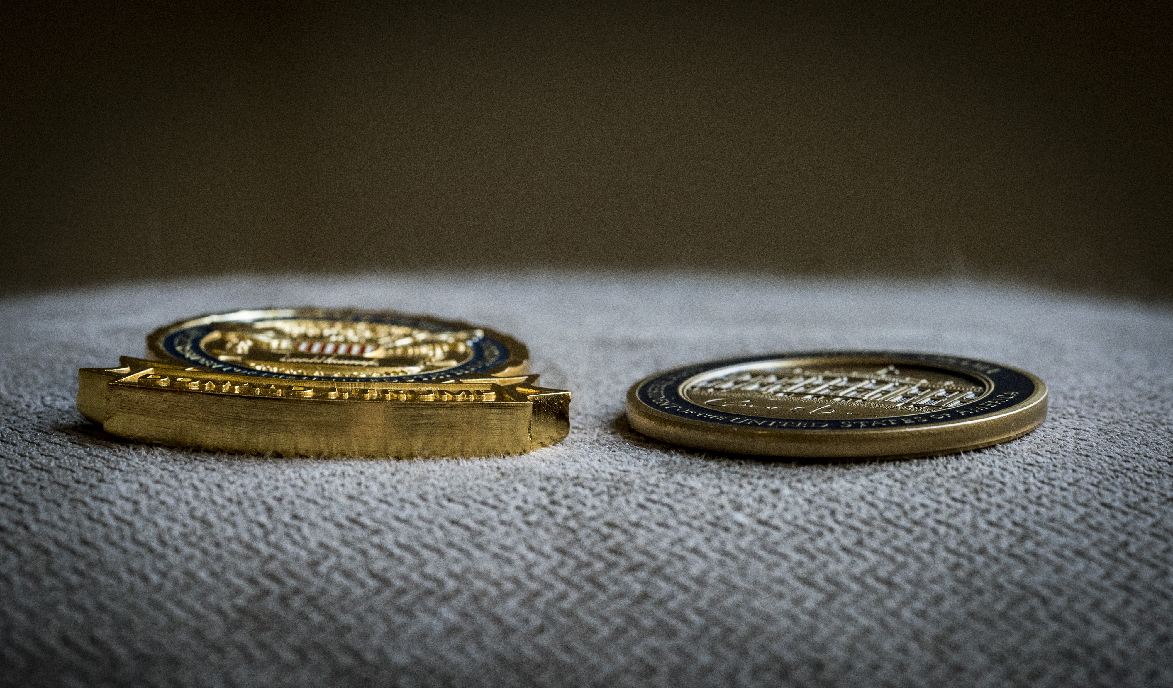 A view of President Trumps' "challenge coin" (left_ as contrasted with former President Obama's.