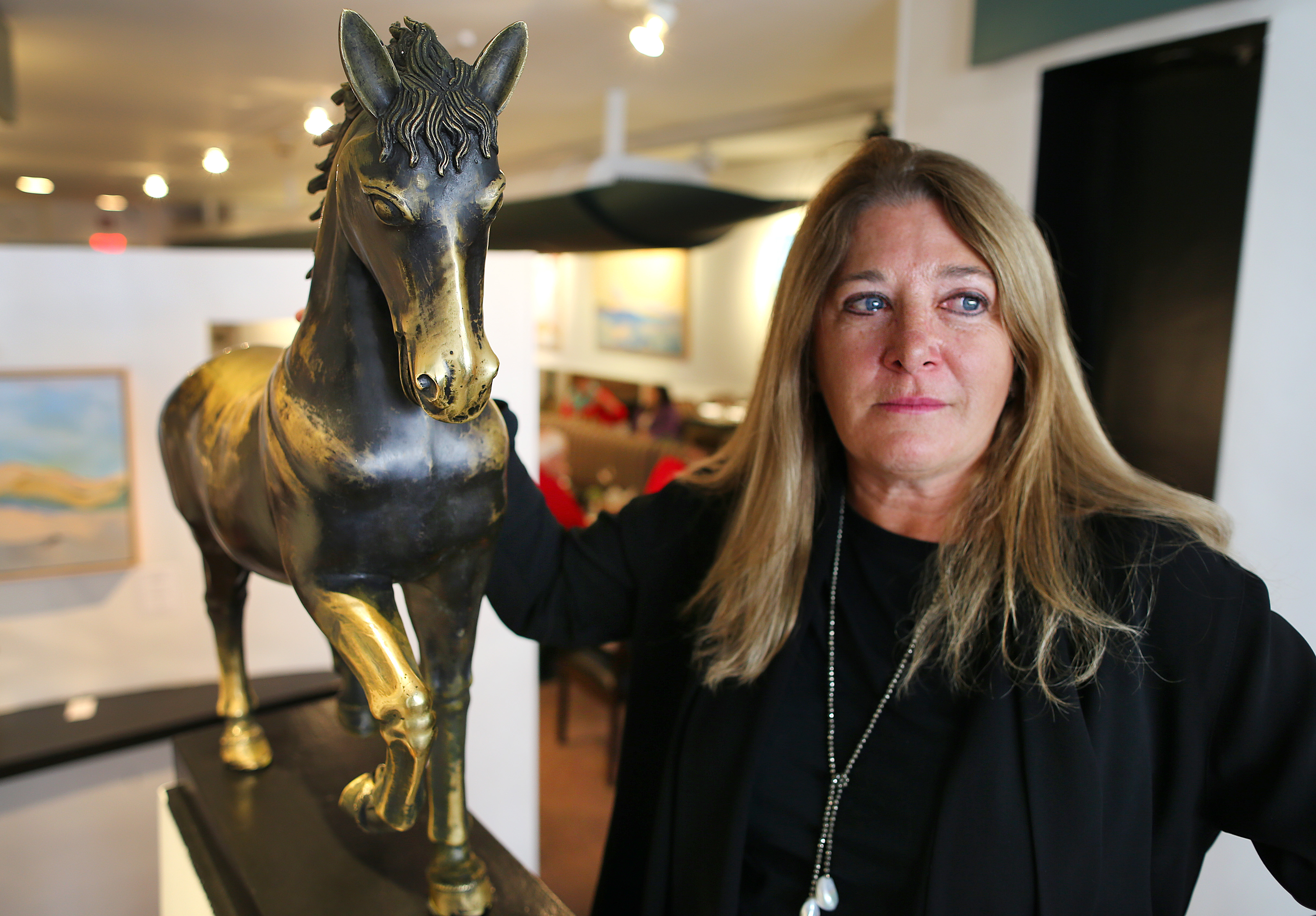 Teary-eyed Debbie Lewis, with her hand on a horse thousands of customers have rubbed for good luck, will close her restaurant 29 Newbury on April 30, her 60th birthday.