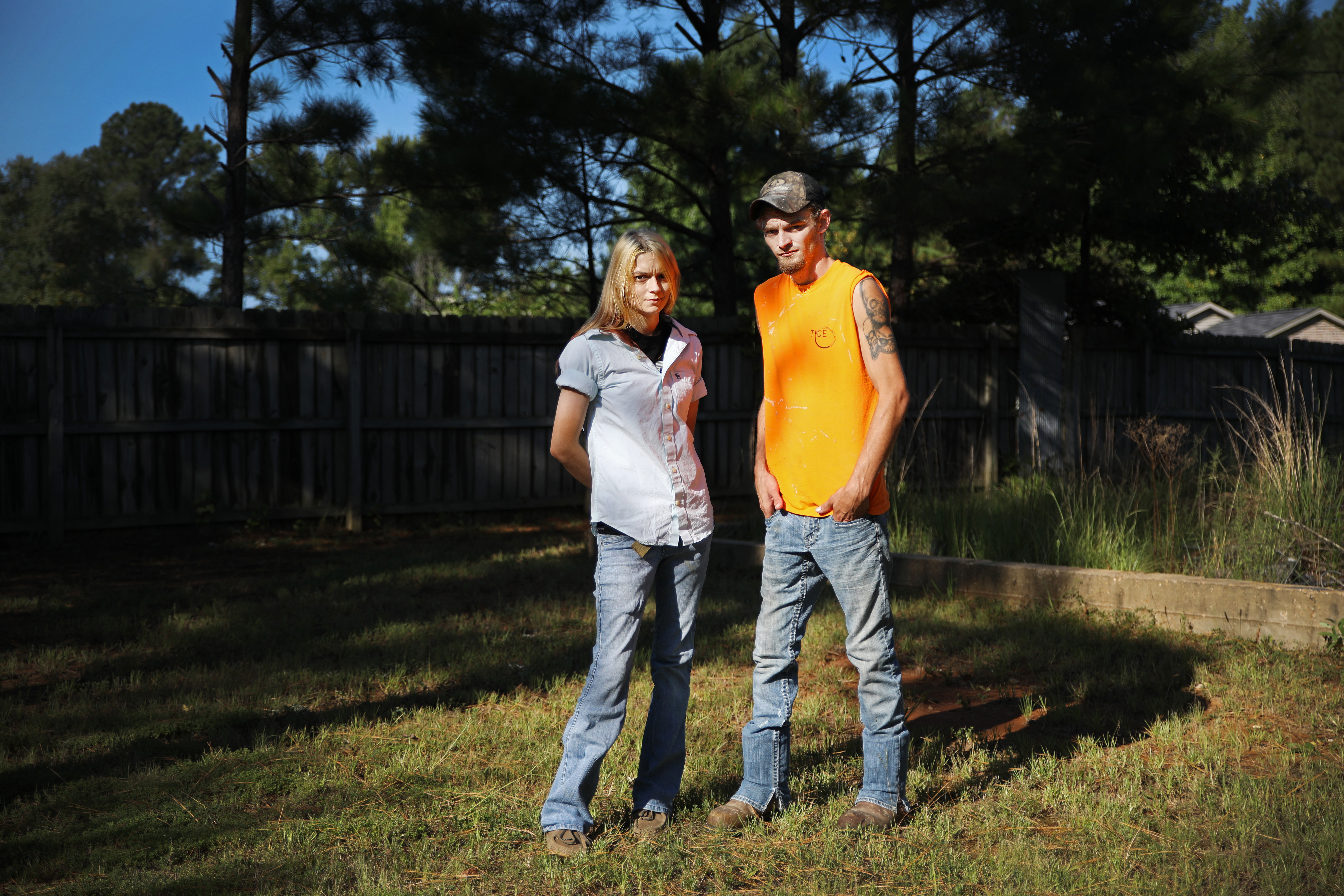 Siblings Lacey and Dylan Mann stood in the front yard of Dylan's home. Their sister, Tami Mann, struggled with drug use and run-ins with CPS while raising her four children.