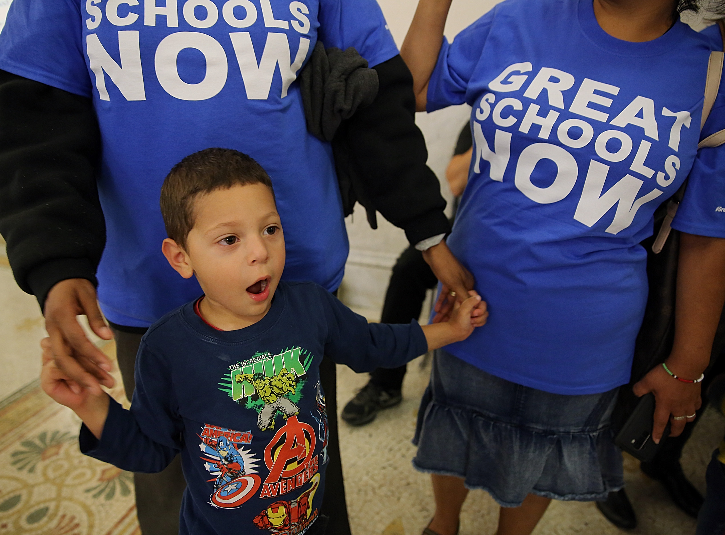 Ignacio Macias, 3, of Lynn attended a charter school campaign rally with his mother, Alicia Javier (left), and Paula Reyes.