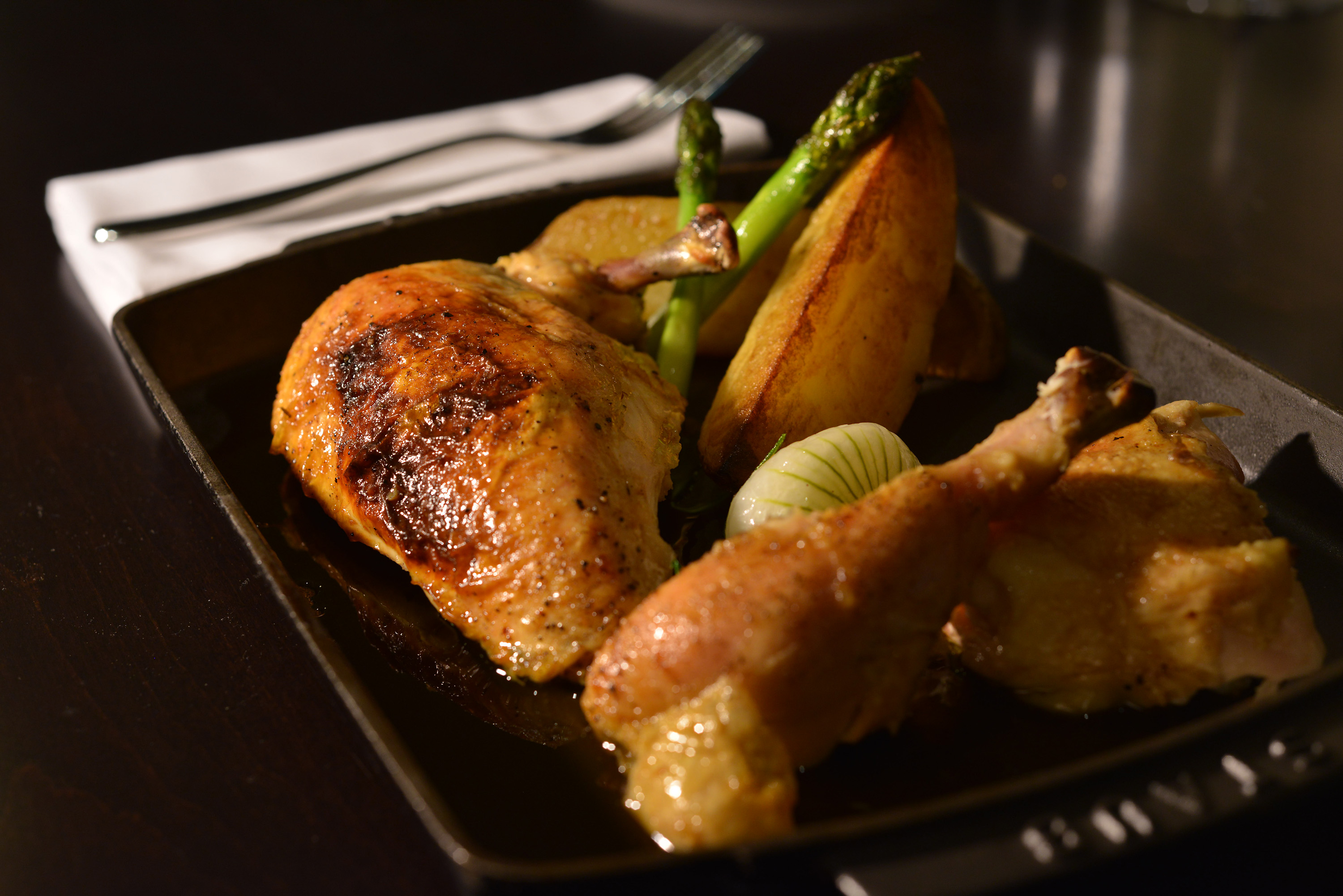 Roasted chicken with ricotta, lemon, roasted potato, and spring onion at Bistro du Midi.