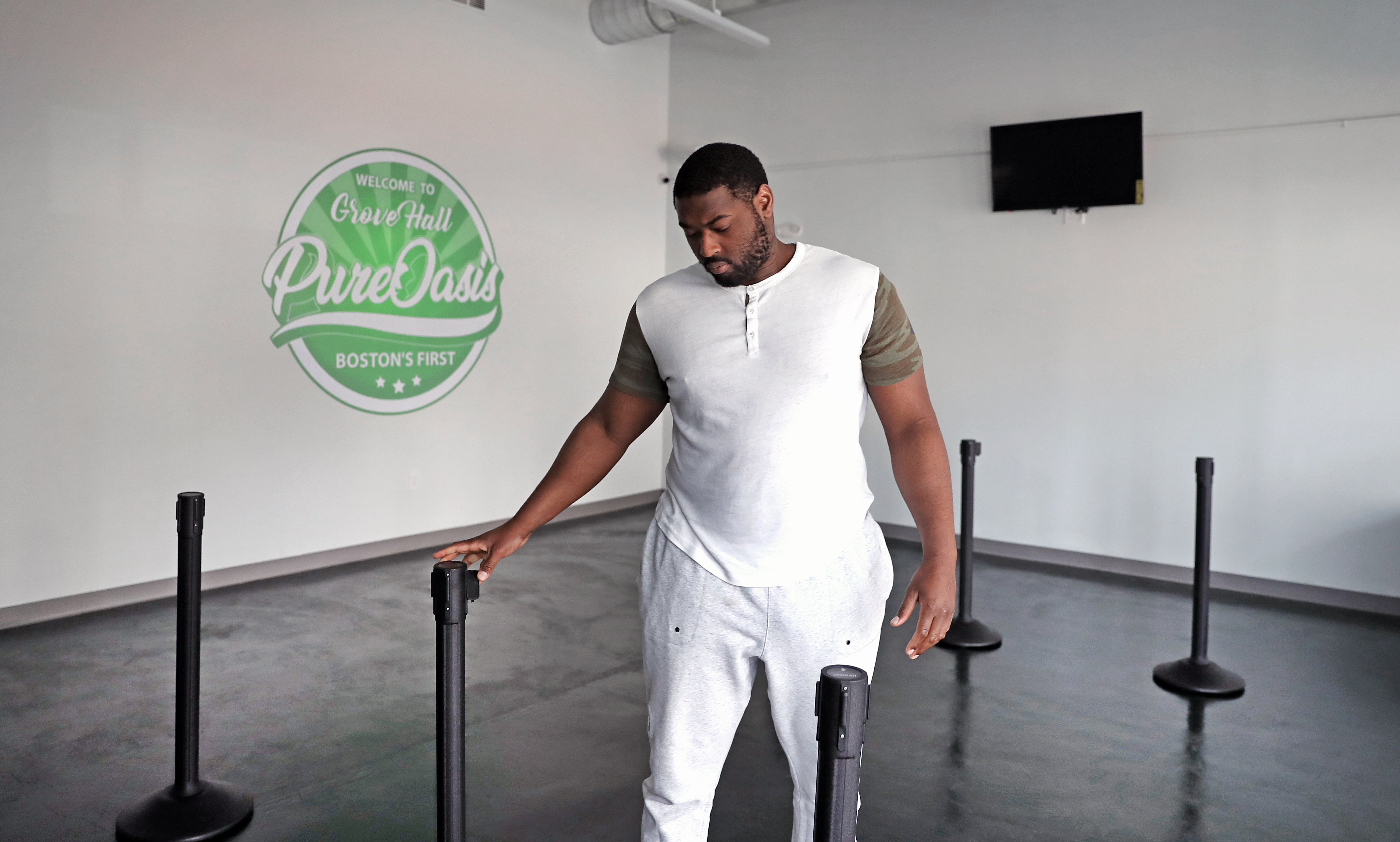 Viondy Merisma, director of security, sets up an entry line for Pure Oasis, Boston's first cannabis store, slated to open Monday.