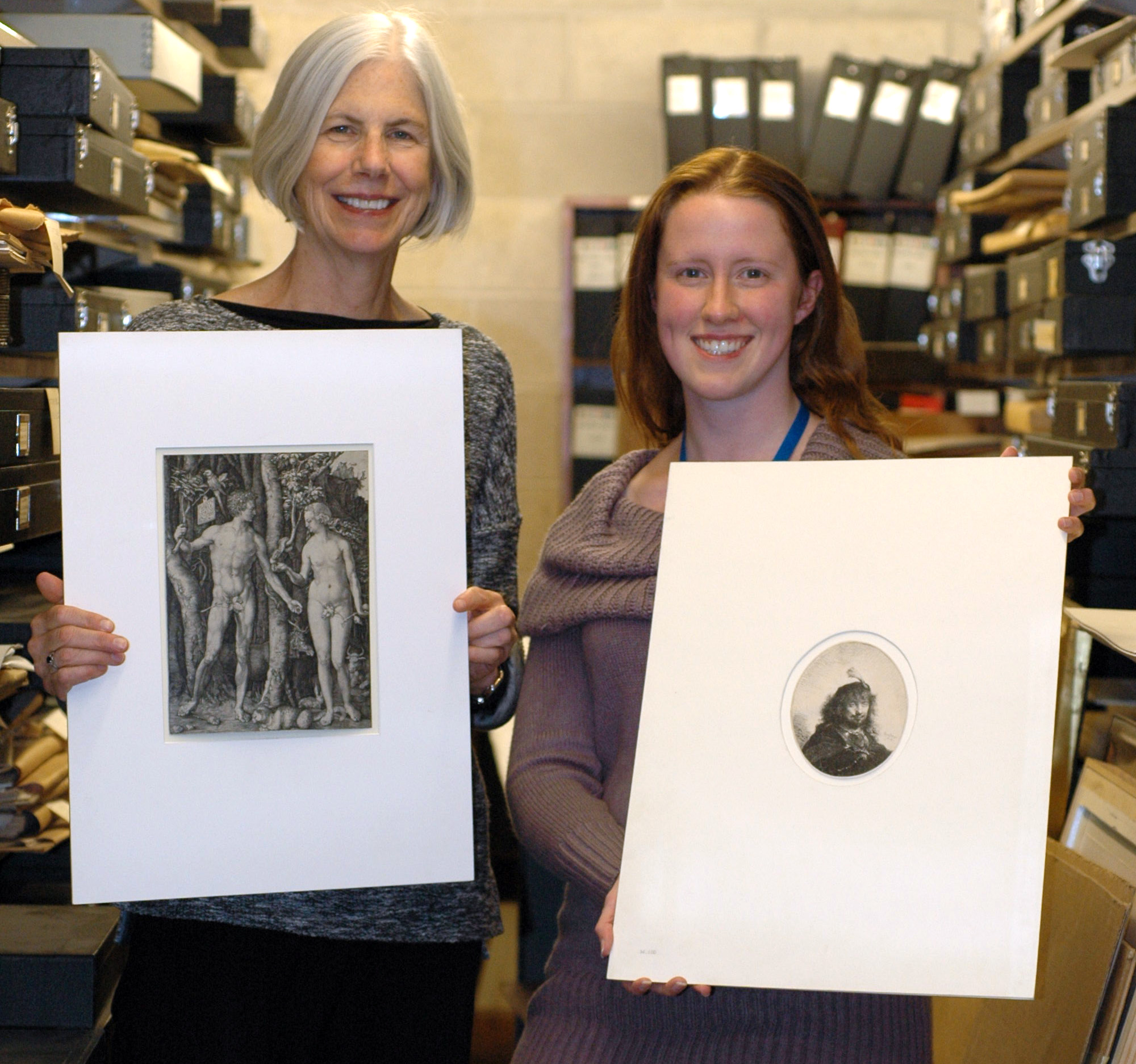 Lauren Schott (right), who found the prints, displayed the Rembrandt while president Amy Ryan held the Dürer.